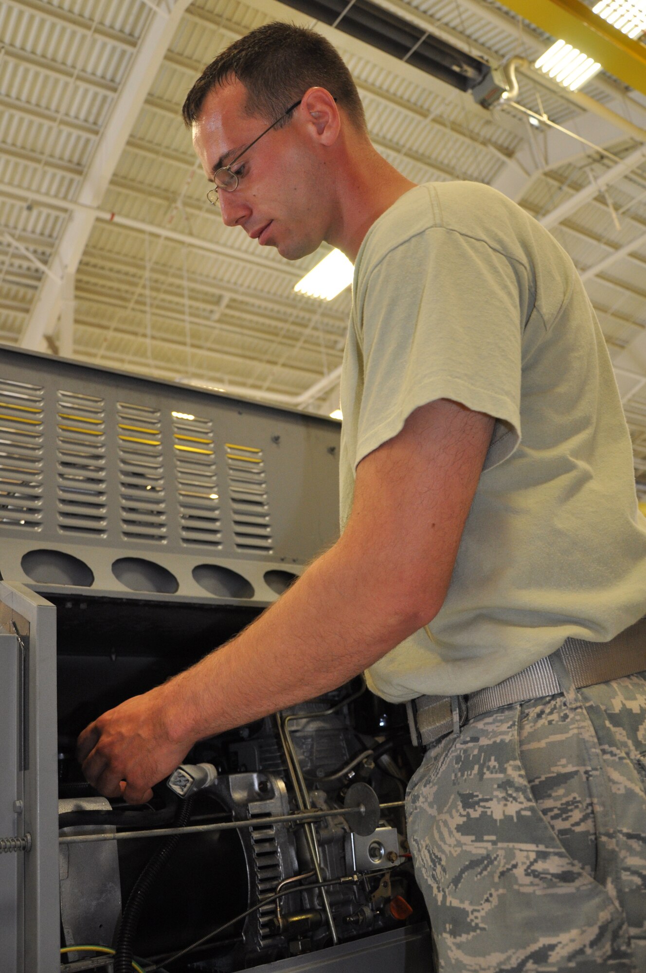 Senior Airman Christopher Blake, 325th Maintenance Squadron aerospace ground equipment technician, disconnects electrical wiring on a new generation heater. (U.S. Air Force photo by Staff Sgt. Rachelle Elsea)