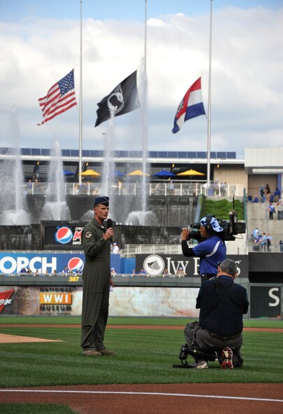 Kansas City, Mo. – Brig. Gen. Eric S. Overturf, 442nd Fighter Wing Commander, delivers a speech to the crowd at Kauffman Stadium while flags fly at half mast behind him at Armed Forces Day hosted by the Kansas City Royals Sept. 15. The 442nd Fighter Wing is an A-10 Thunderbolt II Air Force Reserve unit at Whiteman AFB, Mo. (U.S. Air Force photo by Tech. Sgt. Kent Kagarise/Released).