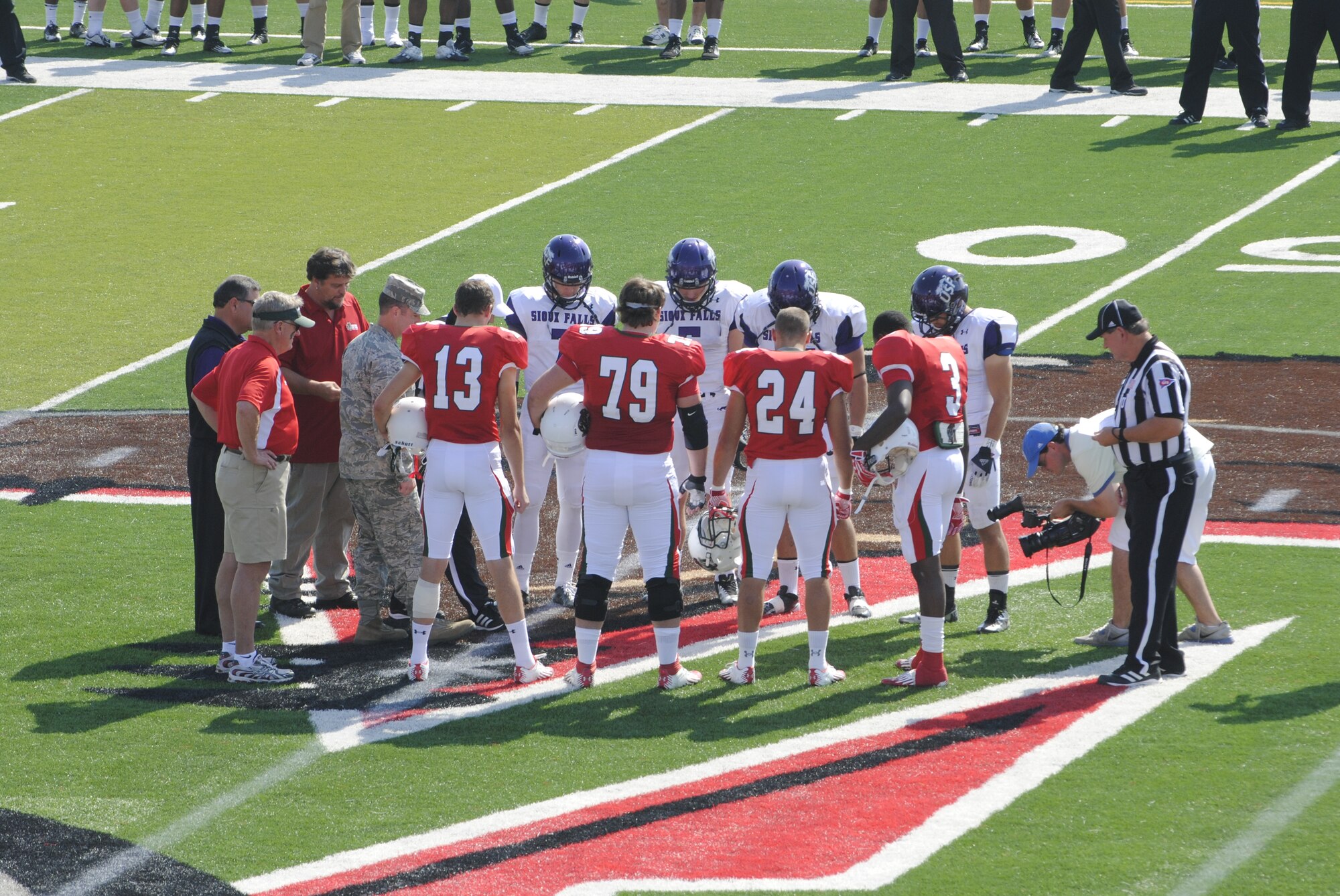 MINOT, N.D. -- Col. Eric H. Froehlich, 5th Maintenance Group commander, takes part in a coin-toss at a local football game between the Minot State University Beavers and the Sioux Falls University Cougars. A B-52H Stratofortress from Minot Air Force Base also conducted a flyover prior to the game. (U.S. Air Force photo/2nd Lt. Jose Davis) 


