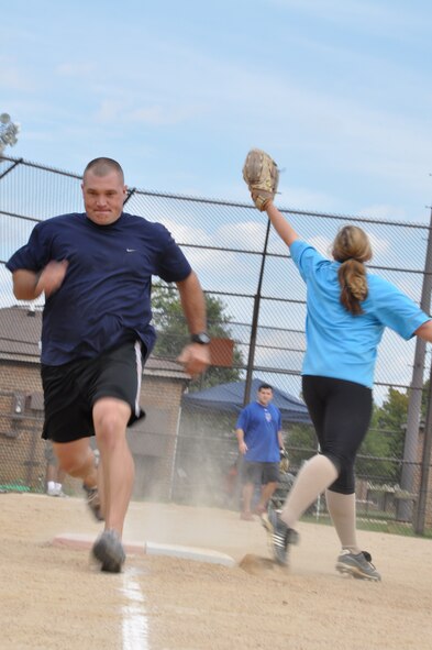 Members from the 459th Maintenance Group play softball during Sports and Fitness Day, at the softball fields, Sept. 16, 2012. This was the Fourth Annual 459 Air Refueling Wing Family Day and the first time incorporating sports into the event. The 459 MXG took home the trophy. (U.S. Air Force photo/ Senior Airman Katie Spencer) 