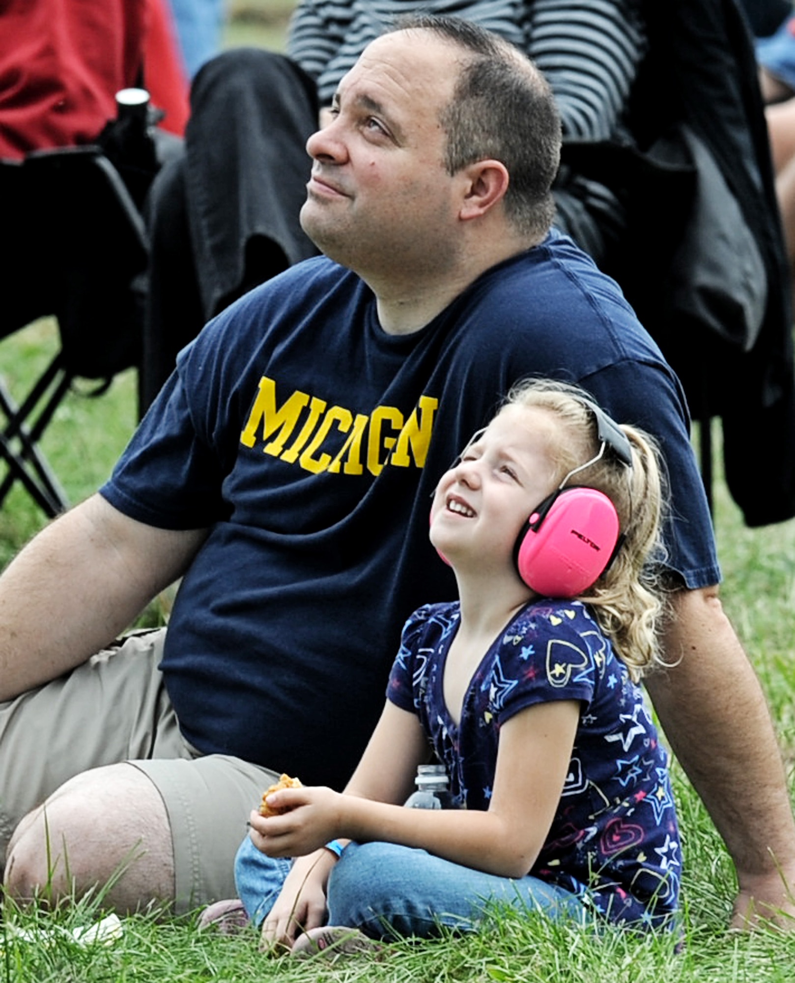 A father and his daughter watch the U.S. Air Force Thunderbirds take-off to begin their show during the 2012 Airpower Over the Midwest air show Sept. 16 at Scott Air Force Base, Ill. The air show featured numerous acts including the United States Special Operations Command para-commandos, U.S. Air Force Thunderbirds as well as hands on static airplane displays. (U.S. Air Force photo/ Staff Sgt. Brian J. Valencia)