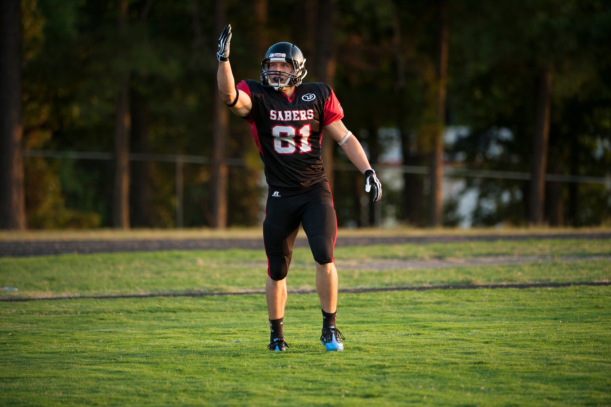 Airman 1st Class Danny Bise salutes the crowd after scoring a touchdown, Aug. 25, 2012. Bise was a key player in the Arkansas Sabers 34-0 win over the Texas Bulldogs. (U.S. Air Force photo by Staff Sgt. Russ Scalf)