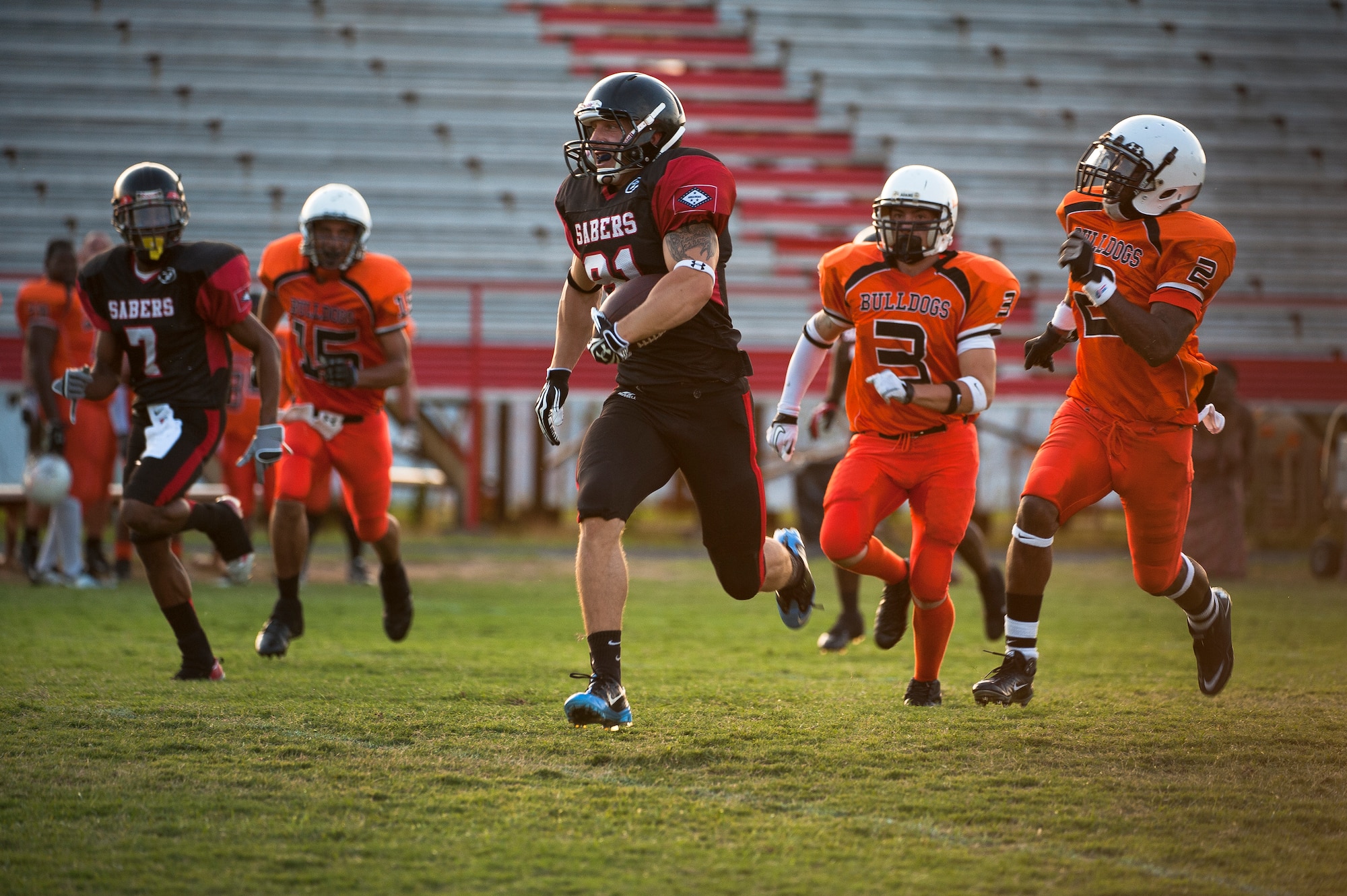 Airman 1st Class Danny Bise runs away from defenders during a 34-0 win over the Texas Bulldogs, Sept. 25, 2012. Bise plays wide receiver for the semi-professional Arkansas Sabers of the Alliance League. (U.S. Air Force photo by Staff Sgt. Russ Scalf)