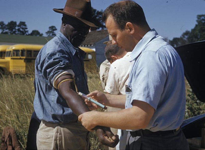 An African American male is tested and treated during the Tuskegee Study of Untreated Syphilis in the Negro Male. According to the Centers for Disease Control and Prevention, the study began in 1932 as U.S. Public Health Service medical personnel conducted these tests without the benefit of patients’ informed consent. (Courtesy photo from the Centers for Disease Control and Prevention/Released)