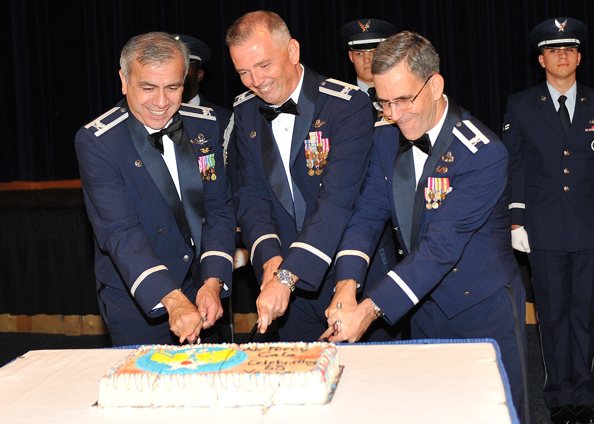 (From left to right) Col. John Hernandez, 184th Intelligence Wing commander, Col. Ricky Rupp, 22nd Air Refueling Wing commander, and Col. Donald Robison, 931st Air Refueling Group maintenance deputy commander, slice the Air Force birthday cake during the 65th Air Force Gala, McConnell Air Force Base, Kan. In the spirit of total force integration, Hernandez, Rupp and Robison came together to prepare the dessert for the Airmen attending the gala. (U. S. Air Force photo/Airman 1st Class Maurice A. Hodges)