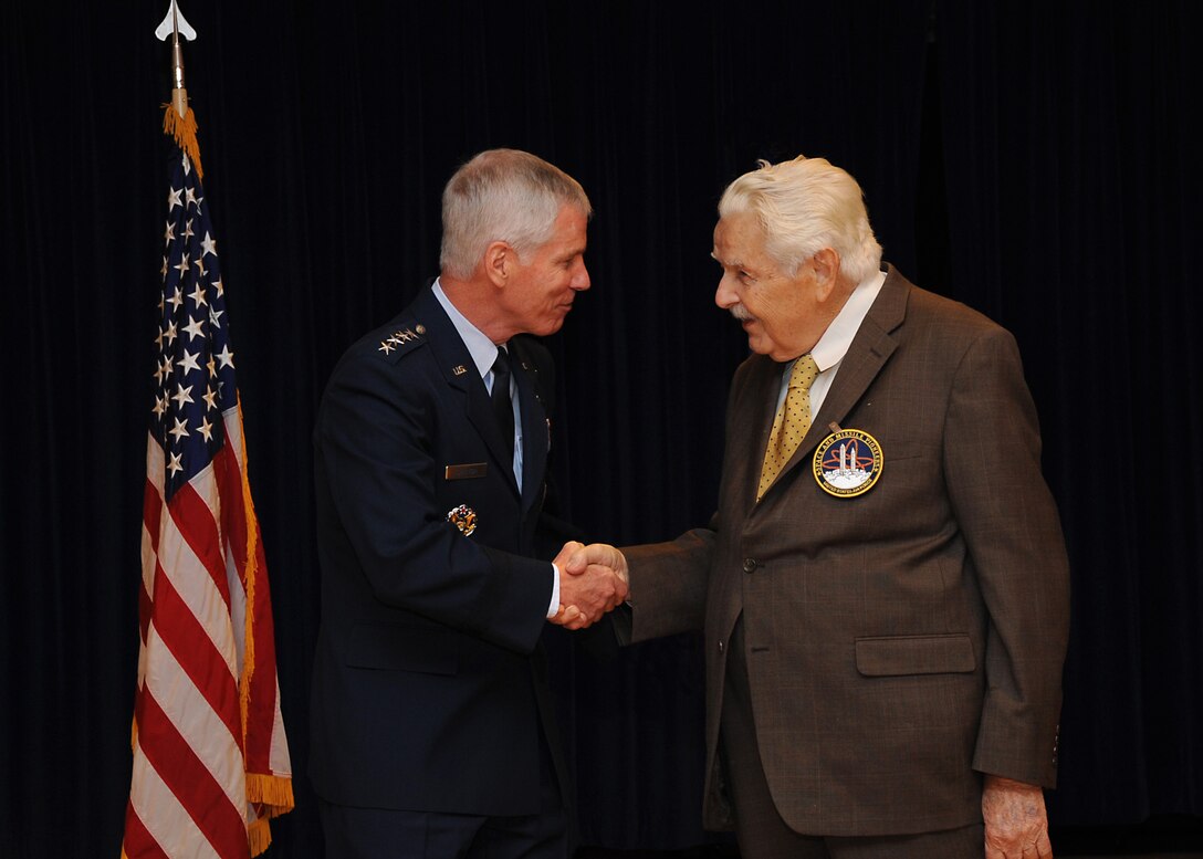 Air Force Space Command commander General William Shelton presents the command's 2012 Air Force Space and Missile Pioneer award to Wilford Stapp Sept. 14 at Peterson AFB, Colo.   Mr. Stapp accepted the posthumous award on behalf of his brother, Pioneer inductee Col. John P. Stapp (Ret.).  The Air Force Space and Missile Pioneer Award recognizes individuals who played a significant role in the history of Air Force space and missile programs, educates Air Force Space Command personnel, Air Force personnel, other DoD members, and the general public about the contributions of significant figures in Air Force space and missile history, generates interest in the study of Air Force space and missile history, and encourages Air Force Space Command and other Air Force personnel to appreciate and understand their space and missile heritage.