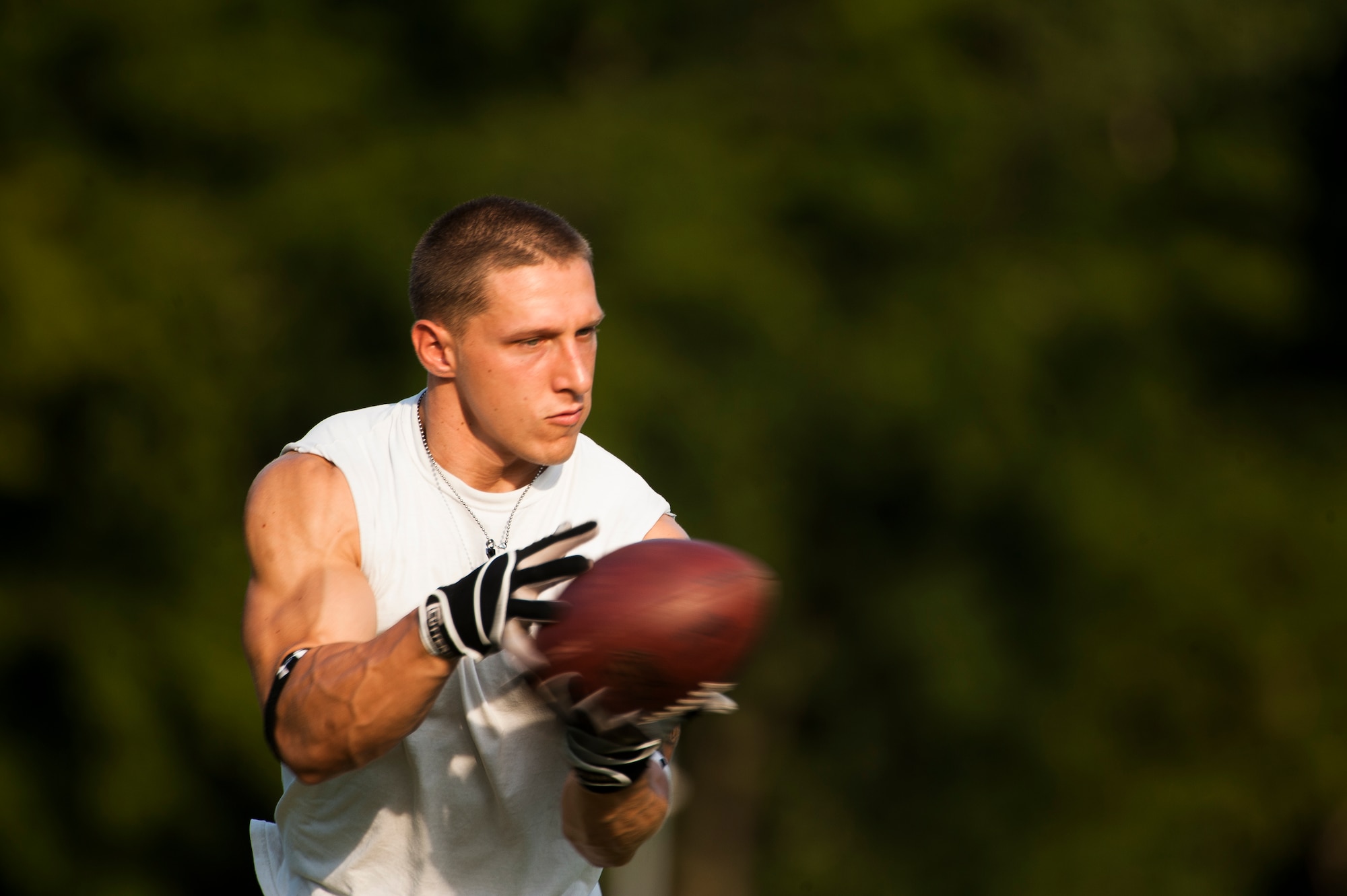 Airman 1st Class Danny Bise catches a football during practice August 23, 2012, at Burns Park, Little Rock, Ark. Bise, an Alabama native, began playing the sport at the age of 8 and now plays for the semi-professional Arkansas Sabers.   (U.S. Air Force photo by Staff Sgt. Russ Scalf)
