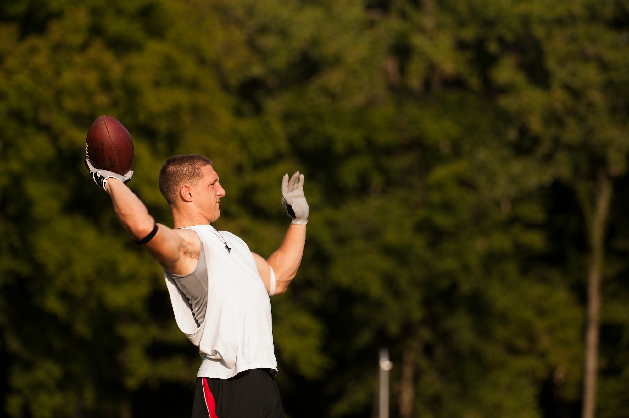 Airman 1st Class Danny Bise throws a football during practice August 23, 2012, at Burns Park in Little Rock, Ark. Bise plays wide receiver for the Arkansas Sabers, a semi-pro football team that plays in the Alliance Football League. (U.S. Air Force photo by Staff Sgt. Russ Scalf)