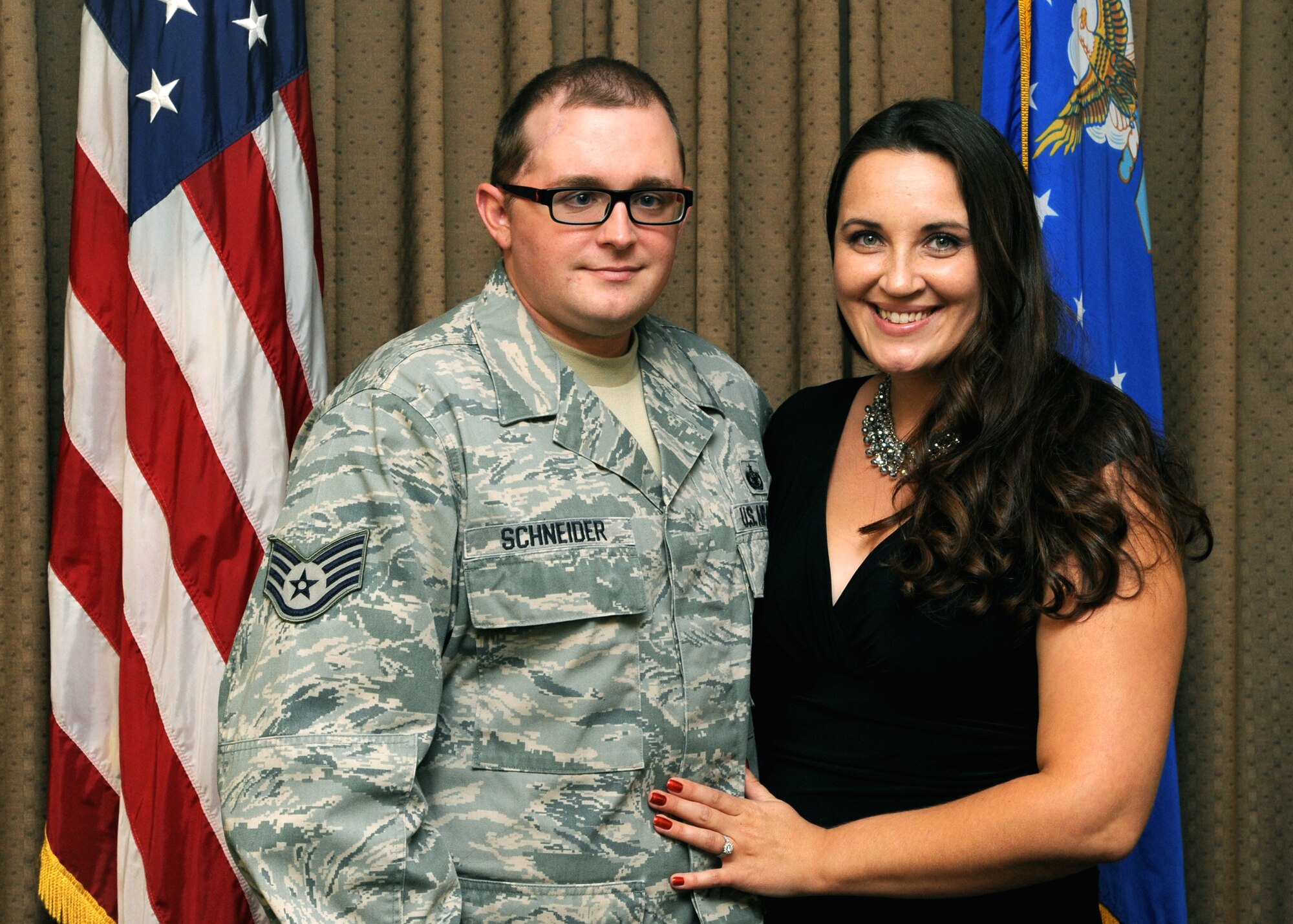 Staff Sgt. Kristoffer Schneider, 319th Security Forces patrolman, and his wife, Amanda, pose after his special retirement ceremony on Sept. 14, 2012, at Grand Forks Air Force Base, N.D.  (U.S. Air Force photo/Senior Airman Amber Bennett)
