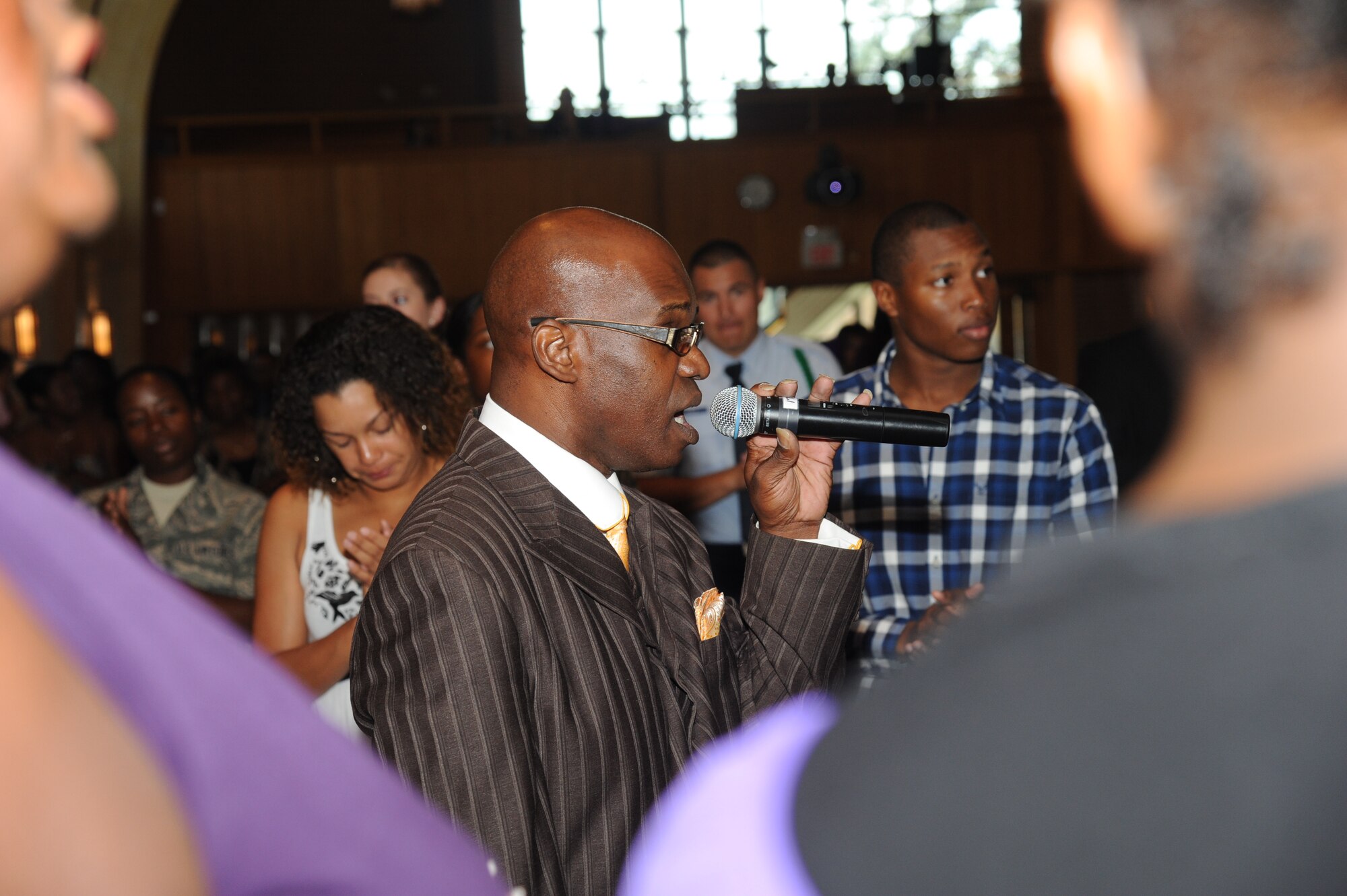 Eddie Franklin, Minister at a local church and a former member of the Keesler Air Force Base Mass Choir, leads a hymn during the 41st Gospel Service Anniversary celebration Sept. 16, 2012, at the Triangle Chapel, Keesler AFB, Miss.  (U.S. Air Force photo by Kemberly Groue)
