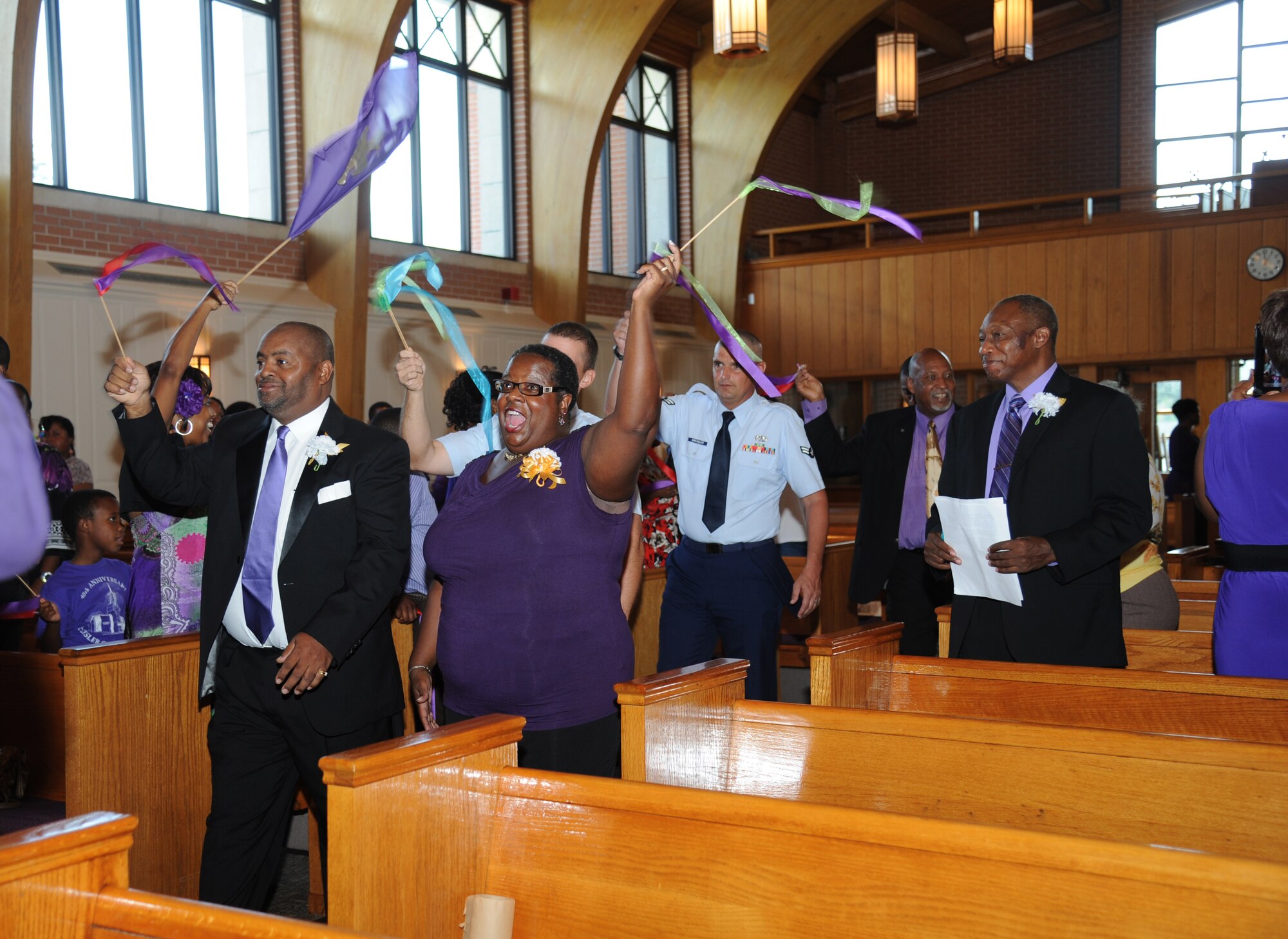 Members of the Keesler Air Force BaseMass Choir sing as the walk down the isle during the 41st Gospel Service Anniversary celebration Sept. 16, 2012, at the Triangle Chapel, Keesler AFB, Miss.  (U.S. Air Force photo by Kemberly Groue)
