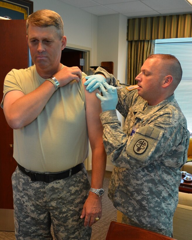 At the U.S. Army TRADOC headquarters on Fort Eustis, Va., Sgt. 1st Class Jeffery S. Bowers, MCAHC's Senior Clinical NCO, administered a flu vaccination to Lt. Gen. David D. Halverson, deputy commanding general, TRADOC.The McDonald Army Health Center is hosting a public flu fair at the Jacobs Theater on Fort Eustis, Oct. 3 from 8 a.m. to 4:30 p.m.; Oct. 11 from 8 a.m. to 4:30 p.m.; and Oct. 25 from 8 a.m. to 8 p.m.   