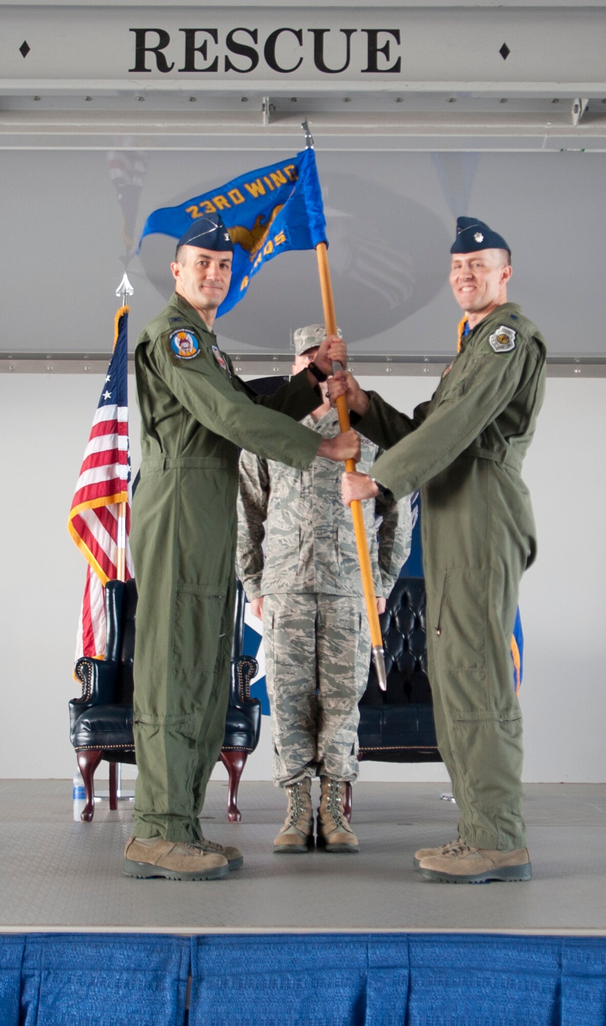 U.S. Air Force Col. Steven Gregg, 347th Rescue Group Commander, passes the guidon to Lt. Col. Shawn Cochran incoming 41st Rescue Squadron commander, during an assumption of command ceremony at Moody Air Force Base, Ga., Sep. 14, 2012. Prior to assuming command of the squadron, Cochran was a doctoral candidate at the University of  Chicago.(U.S. Air Force photo by Airman 1st Class Paul Francis/Released)