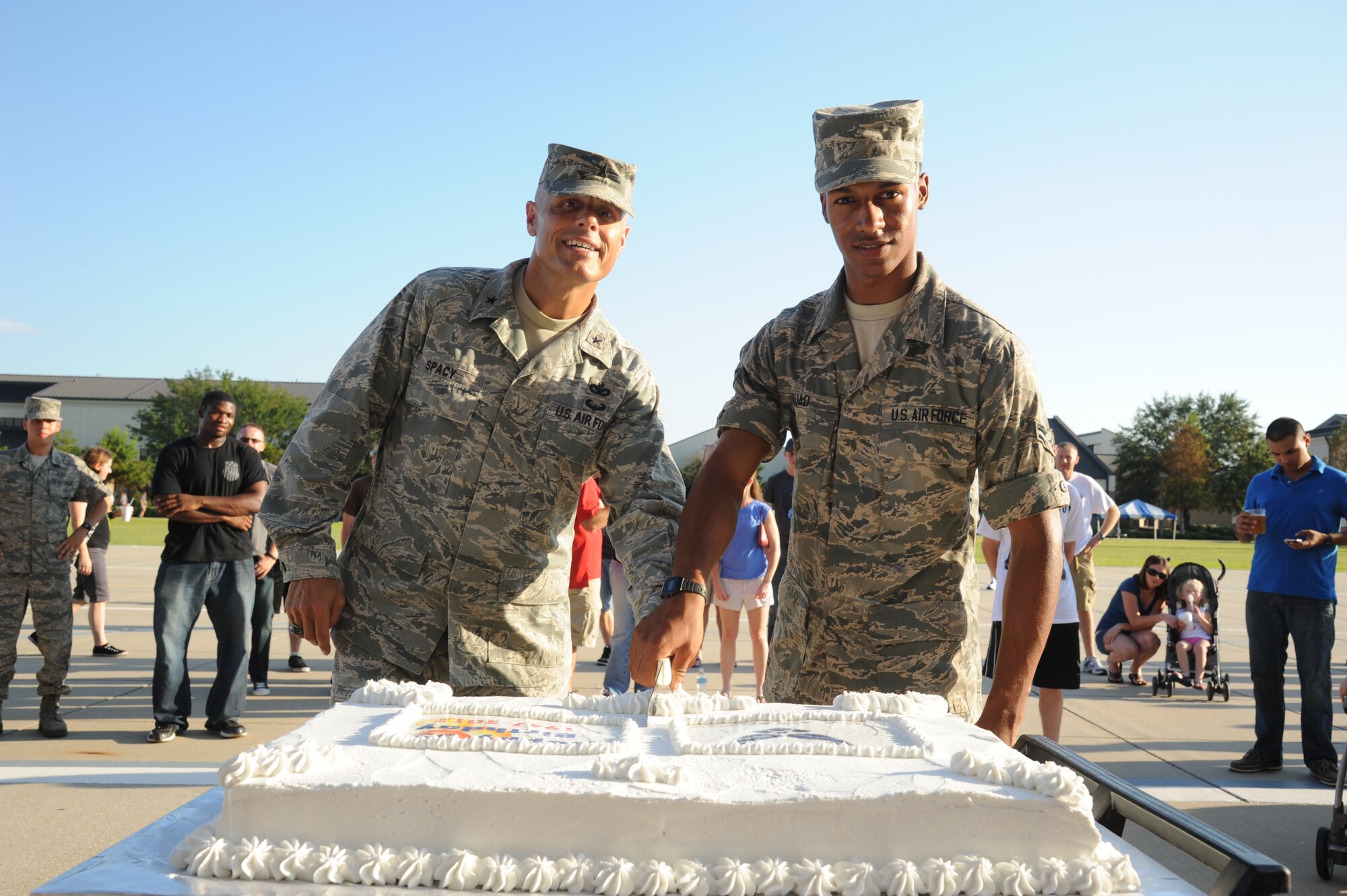 Brig. Gen. Bradley Spacy, 81st Training Wing commander, is assisted by the youngest airman at Keesler, Airman 1st Class Youseff Fouad, 338th Training Squadron, in the cake cutting ceremony at the 65th Air Force Birthday Celebration event at the Triangle Sept. 14, 2012, at Keesler Air Force Base, Miss. The event featured live music, food, beverages, games, contests and prizes.  (U.S. Air Force photo by Kemberly Groue)