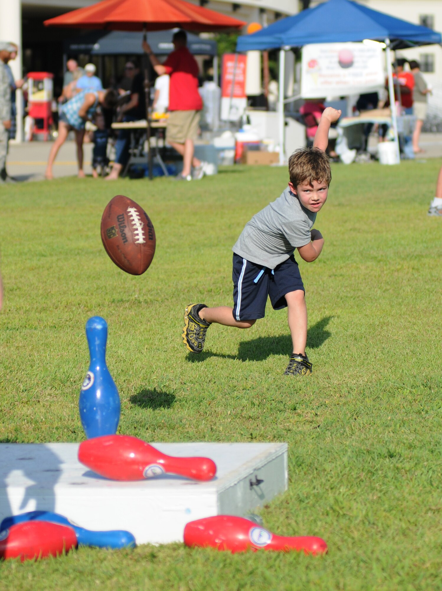 Five-year-old Garrison McMillan, son of Kelly and Master Sgt. Gregory McMillan, 81st Logistics Readiness Squadron, takes a turn in football bowling at the 65th Air Force Birthday Celebration event at the Triangle Sept. 14, 2012, at Keesler Air Force Base, Miss. The event featured live music, food, beverages, games, contests and prizes. (U.S. Air Force photo by Kemberly Groue)
