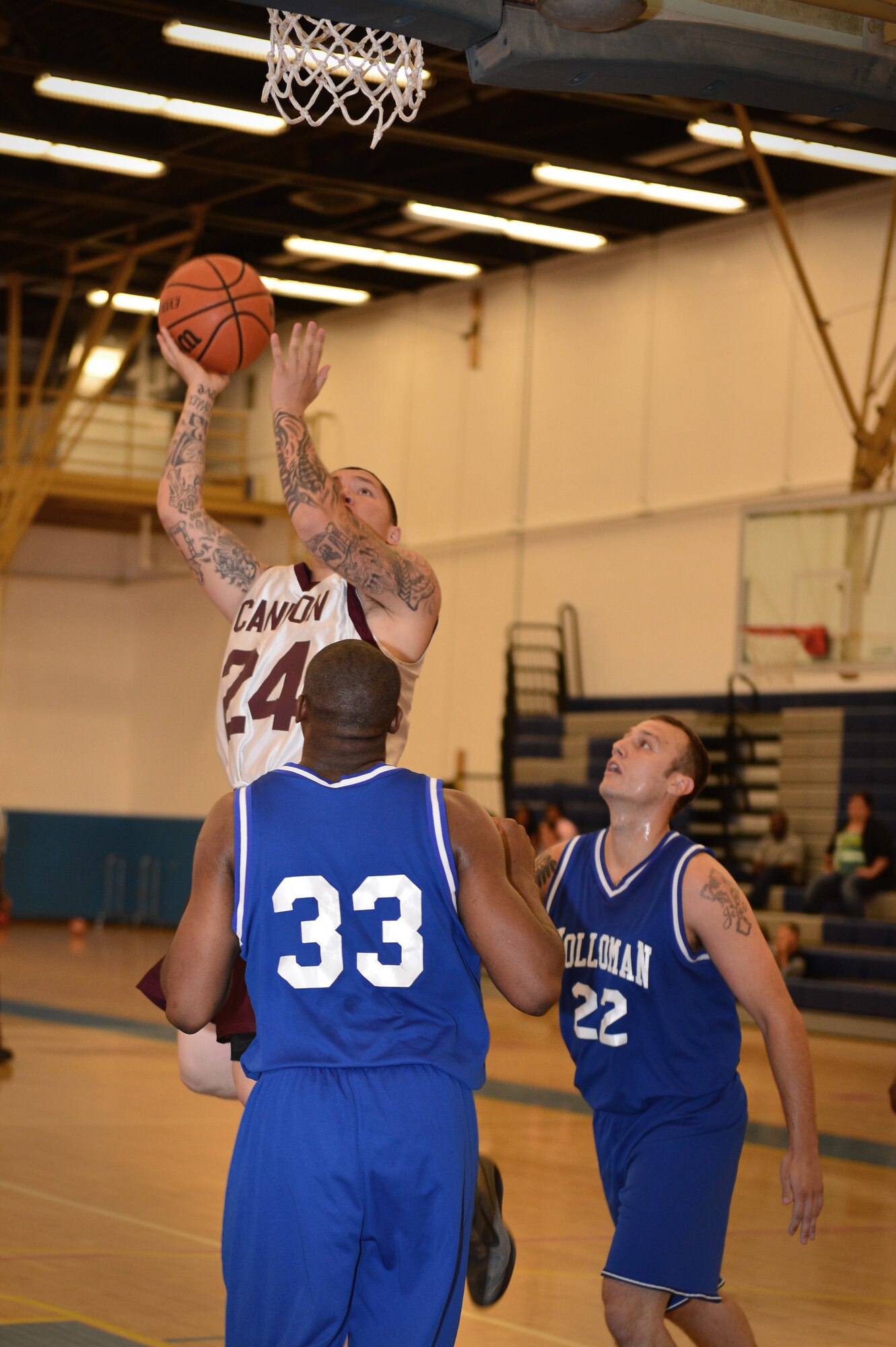 U.S. Air Force Airman 1st Class Charles Herrero, 27th Special Operations Aircraft Maintenance Squadron, goes up for a lay up during the basketball game in the Fitness Center at Cannon Air Force Base, N.M., Sept. 15, 2012. Cannon's varsity basketball team hosted a double header versus Holloman Air Force Base, N.M. (U.S. Air Force photo/Airman 1st Class Eboni Reece)