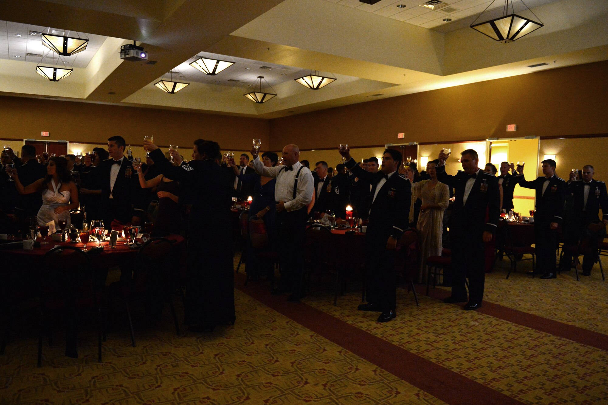 Guests of the Air Force Ball toast after a speech and closing remarks by U.S. Air Force Col. Buck Elton, 27th Special Operations Wing commander. The Air Force Ball is an annual Air Force-wide tradition to celebrate the heritage and history of the Air Force. (U.S. Air Force photo/Airman 1st Class Eboni Reece)