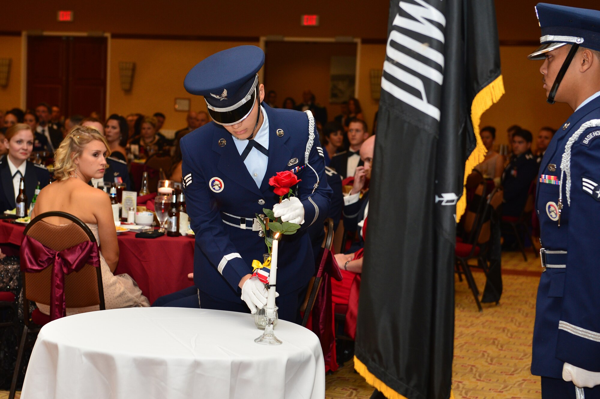 U.S. Air Force Airman 1st Class Kaisy Maldonado, 27th Special Operations Force Support Squadron food service apprentice, places a vase with a rose on the table during the Prison of War/ Missing in Action tribute during the Air Force Ball at the Civic Center in Clovis, N.M., Sept. 15, 2012. The Air Force Ball is an annual Air Force-wide tradition to celebrate the heritage and history of the Air Force. (U.S. Air Force photo/Airman 1st Class Eboni Reece)