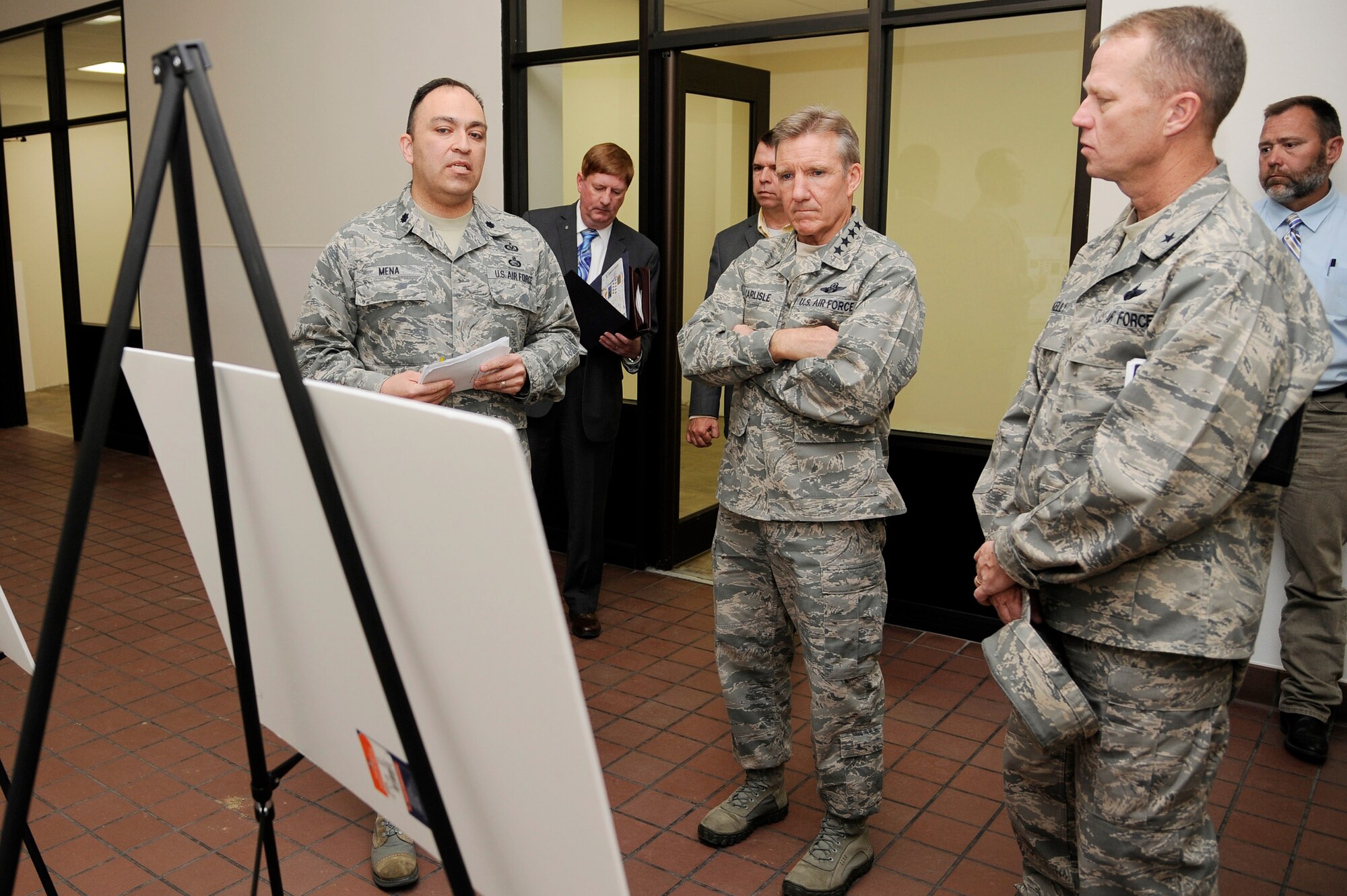 U.S. Air Force Gen. “Hawk” Carlisle, Pacific Air Forces commander, is briefed by Brig. Gen. Mark Kelly, 354th Fighter Wing commander, and Lt. Col. Frederick Mena, 354th Force Support Squadron commander, about the future plans of the Eielson City Center during a base visit Aug. 22, 2012, Eielson Air Force Base, Alaska. The Eielson City Center will be a consolidated service facility for the base community due open in December 2012. (U.S. Air Force photo/Staff Sgt. Jim Araos)