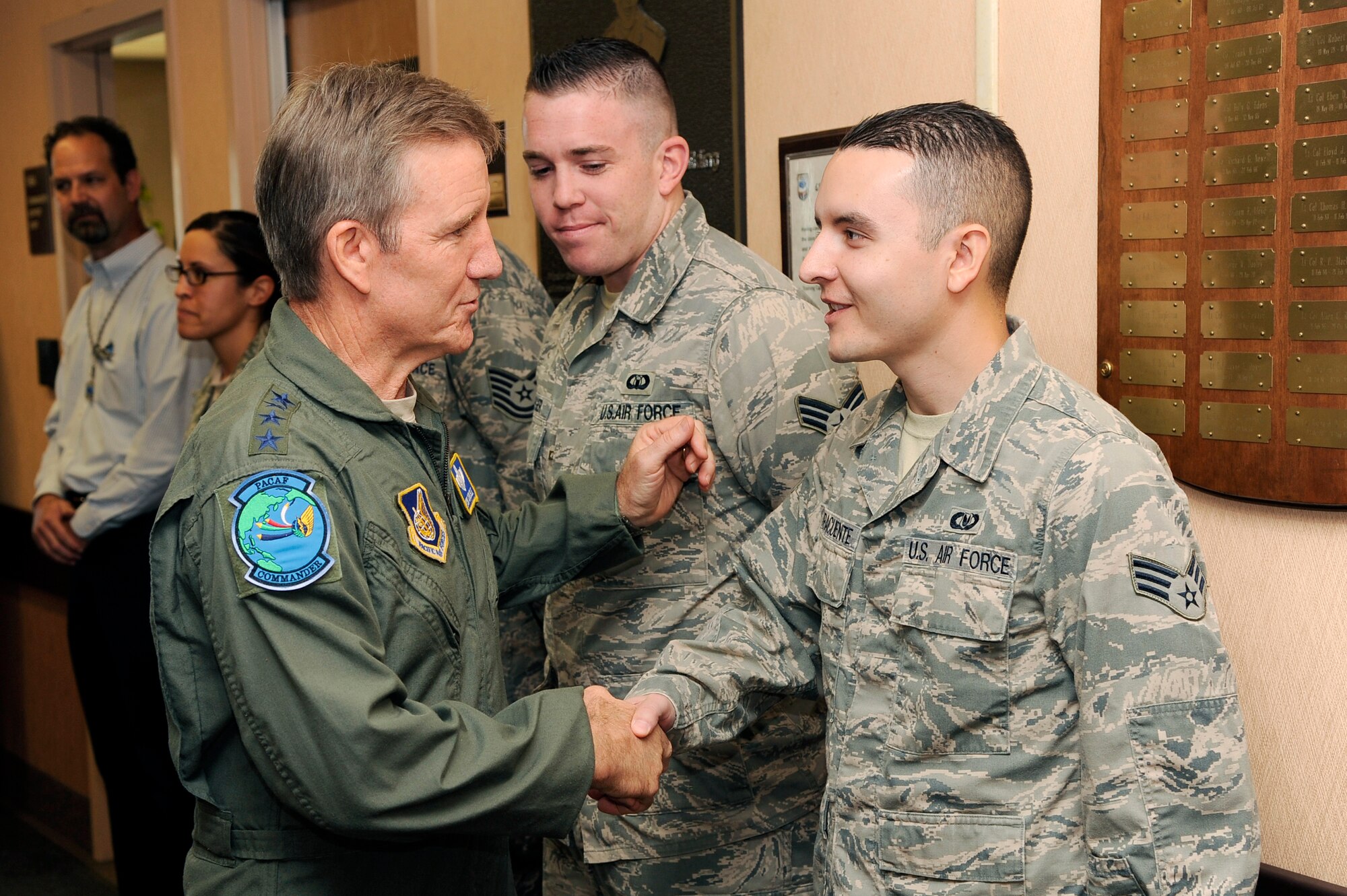 U.S. Air Force Gen. “Hawk” Carlisle, Pacific Air Forces commander, presents a coin to Senior Airman Osvaldo Laracuente, 354th Operations Support Squadron aircrew flight equipment technician, during a base visit Aug. 22, 2012, Eielson Air Force Base, Alaska. Carlisle presented coins to several of Eielson’s outstanding performers throughout his visit. (U.S. Air Force photo/Staff Sgt. Jim Araos)