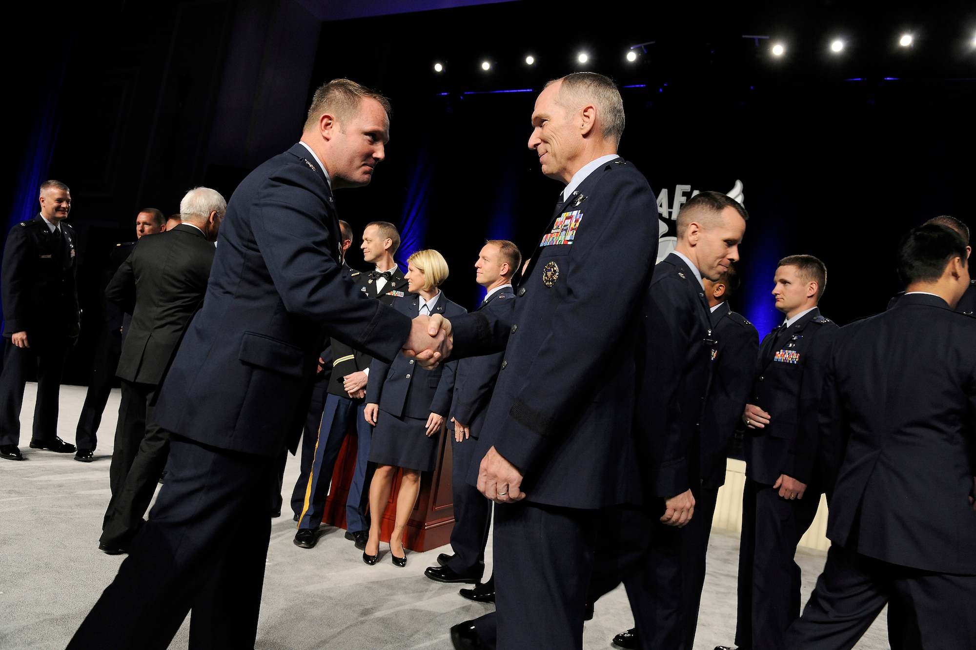 Gen. Michael Hostage congratulates an award recipient during the opening ceremonies of the Air Force Association's Air and Space Conference and Technology Exposition in Washington, D.C., Sept. 17, 2012. Hostage is commander of Air Combat Command. (U.S. Air Force photo/Scott M. Ash)