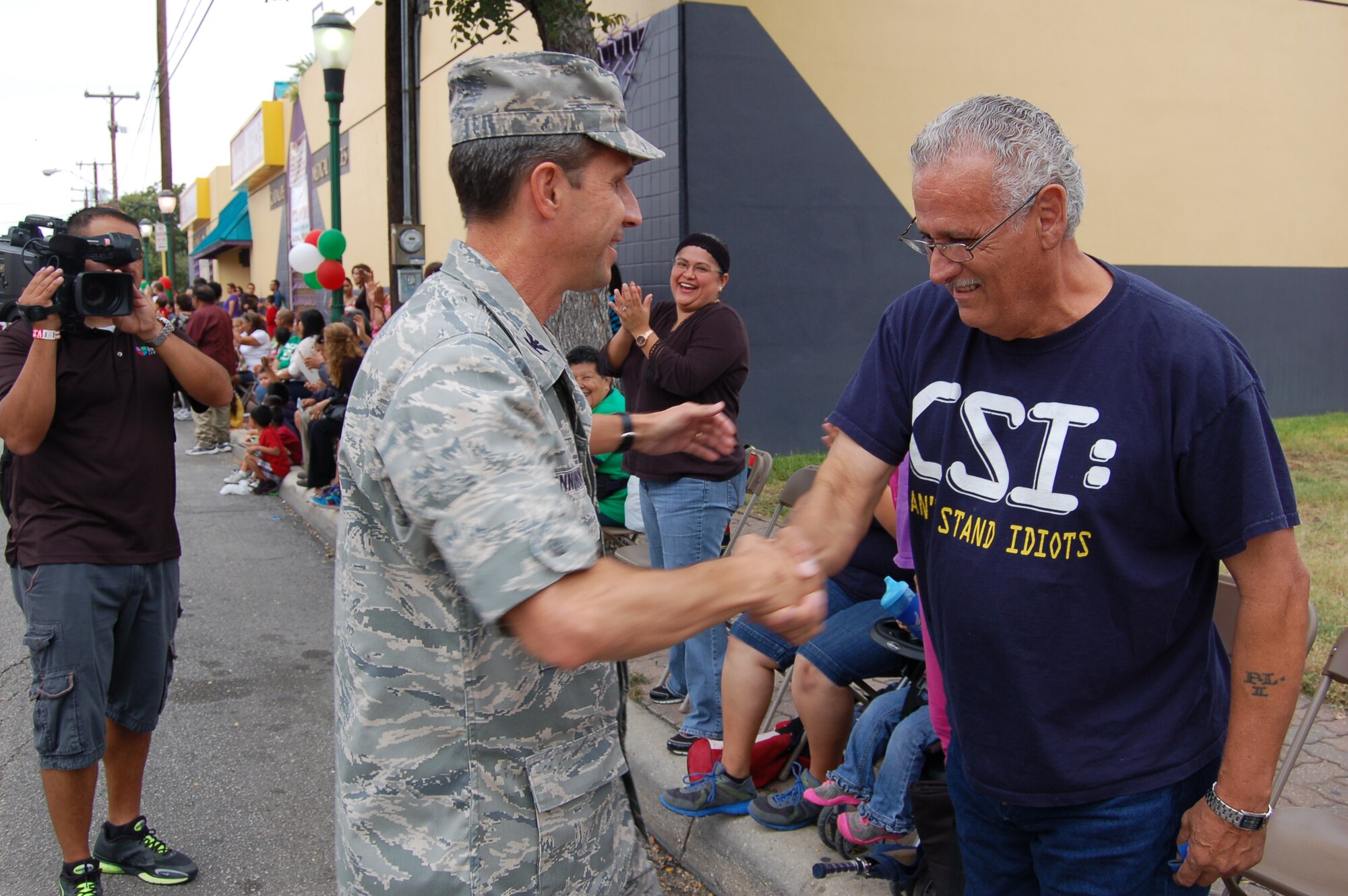 Col. Jeffrey T. Pennington, 433rd Airlift Wing commander, thanks a military veteran for his service during the 31st Annual Dieciseis parade in San Antonio Sept. 15, 2012.  "Dieciseis," or Sept. 16, commemorates Mexico's declared independence from Spanish rule in 1810.  The 433rd AW, or "Alamo Wing," is an Air Force Reserve unit located at Joint Base San Antonio-Lackland, Texas.
