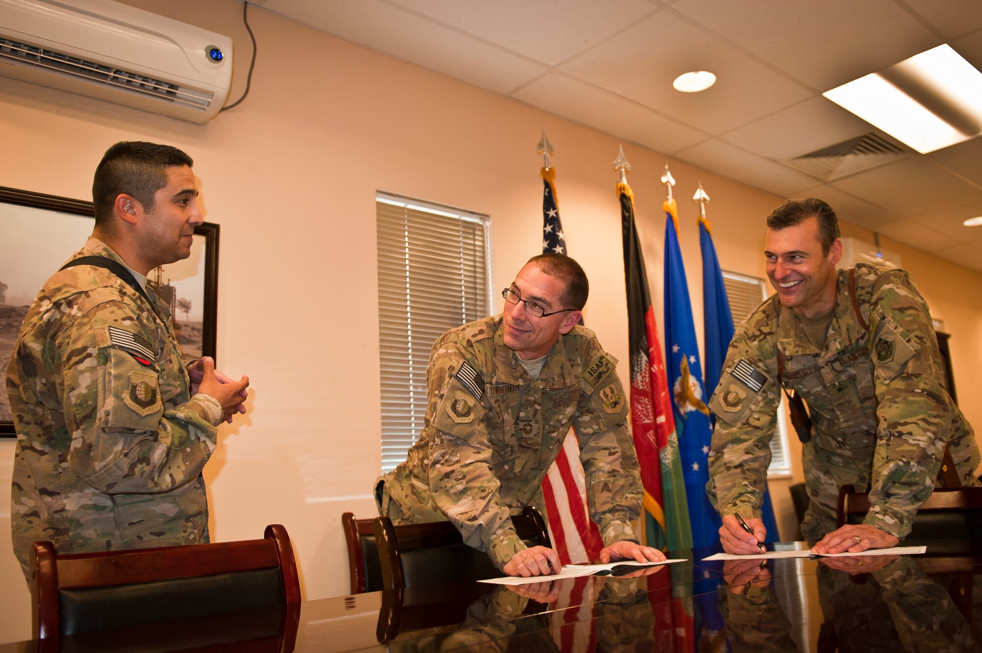 Brig. Gen. Joseph Guastella, 455th Air Expeditionary Wing commander, and CMSgt Toberman, 455th Expeditionary Operations Group superintendent, speak to SSgt Neal Uranga, 455 AEW staff agencies Combined Federal Campaign-Overseas unit representative, at they fill out contribution forms at Bagram Airfield, Afghanistan, Sept. 17, 2012. For the next two months, CFC-O unit representatives will make their way around the 455 AEW offering deployed Airmen the opportunity to give to charities of their choice. (U.S. Air Force Photo/Capt. Raymond Geoffroy)