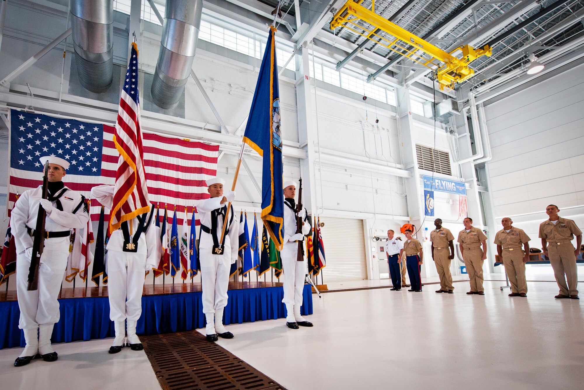 The new chief petty officer selectees watch as Naval Air Station Pensacola’s color guard presents the colors at the beginning of a chief petty officer pinning ceremony held by the Navy's F-35 Lightning II squadron, VFA-101, Sept. 14 at Eglin Air Force Base, Fla. The ceremony formally marks the transition from E-6 to chief.  There were four Sailors who pinned on the new rank. A Marine and a Soldier were also pinned as honorary chiefs.  (U.S. Air Force photo/Samuel King Jr.)