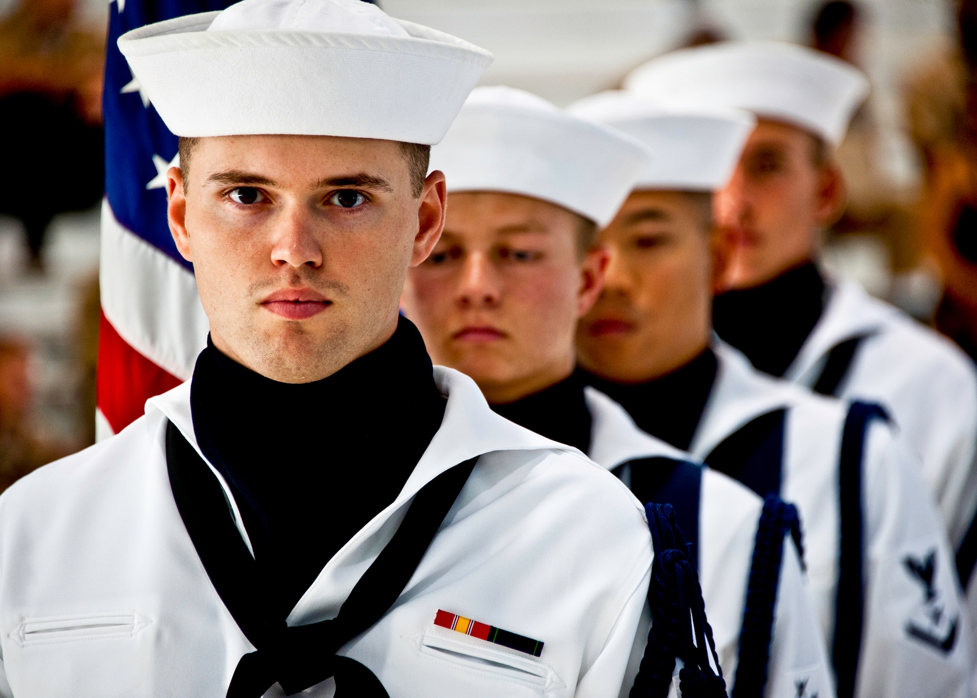 A Sailor with Naval Air Station Pensacola’s color guard waits to bring in the colors at the beginning of a chief petty officer pinning ceremony held by the Navy's F-35 Lightning II squadron, VFA-101, Sept. 14 at Eglin Air Force Base, Fla.  The ceremony formally marks the transition from E-6 to chief.  There were four Sailors who pinned on the new rank. A Marine and a Soldier were also pinned as honorary chiefs. (U.S. Air Force photo/Samuel King Jr.)