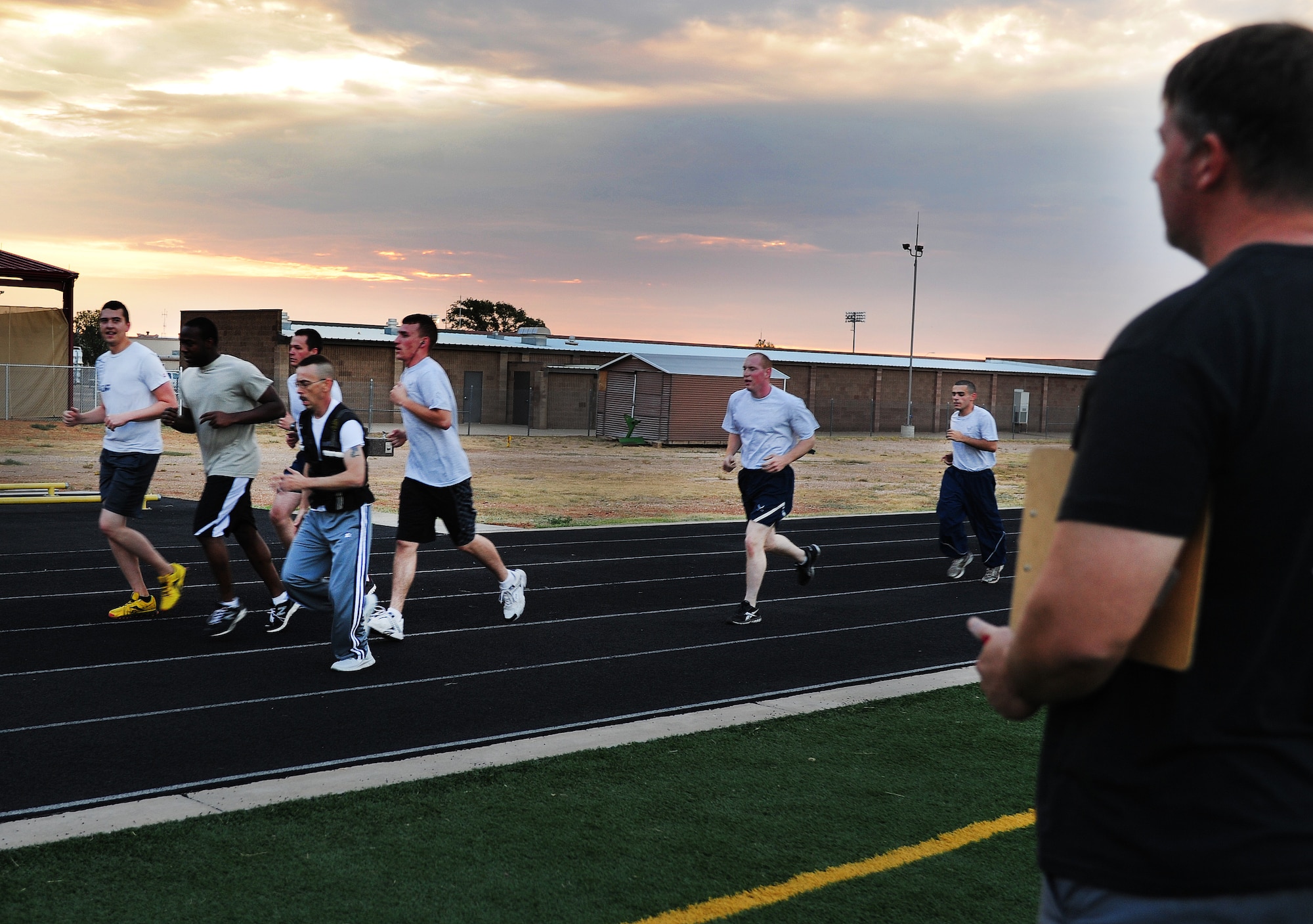 Anthony Cook, 27th Special Operations Aerospace Medicine Squadron, exercise physiologist, times participants during Health and Wellness Center physical training at Cannon Air Force Base, N.M., Sept. 12, 2012. The HAWC PT program is designed to help individuals advance their overall fitness and improve their score on the Air Force PT test. (U.S. Air Force photo/Airman 1st Class Ericka Engblom)