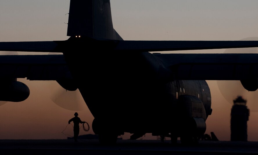In the light of the setting sun of Sept. 14, 2012 a 133rd Airlift Wing C-130 “Hercules” cargo aircraft starts engines prior to a late night mission on the tarmac Minnesota Air National Guard Base St. Paul, Minnesota. The 133rd Airlift Wing provides the U.S. Air Force with tactical airlift support as well as support to the State of MInnesota in case of disaster or emergency. U.S. Air Force photo by Tech. Sgt. Erik Gudmundson/released
