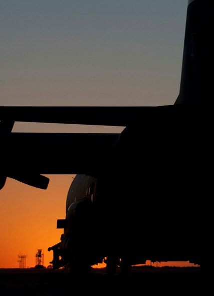 In the light of the setting sun of Sept. 14, 2012 a 133rd Airlift Wing C-130 “Hercules” cargo aircraft starts engines prior to a late night mission on the tarmac Minnesota Air National Guard Base St. Paul, Minnesota. The 133rd Airlift Wing provides the U.S. Air Force with tactical airlift support as well as support to the State of MInnesota in case of disaster or emergency. U.S. Air Force photo by Tech. Sgt. Erik Gudmundson/released
