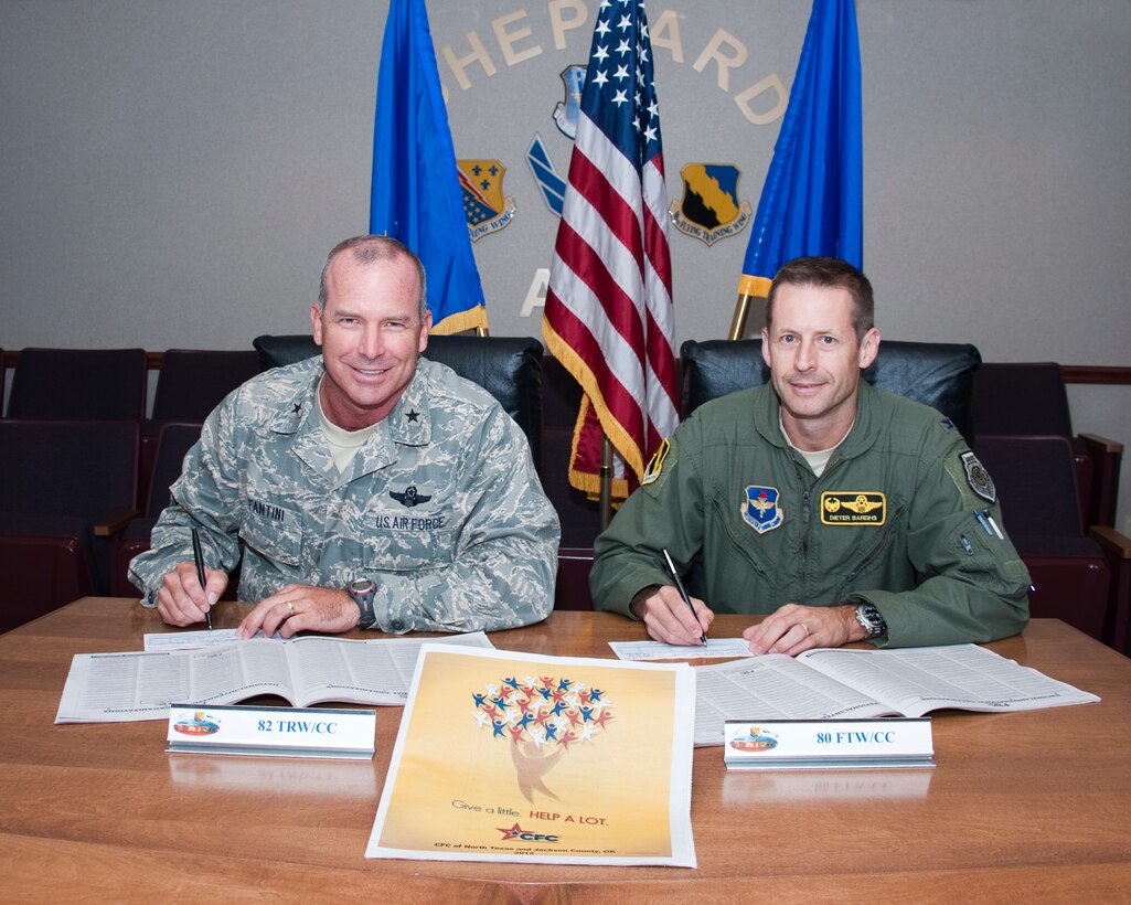 Brig.Gen. Michael Fantini, 82nd Training Wing Commander, and Col. Dieter Bareihs, 80th Flying Training Wing Commander, sign pledge cards for the kickoff of the Combined Federal Campaign on Sept. 13, 2012 at Sheppard Air Force Base, Texas. (U.S. Air Force Photo by Danny Webb) (Released)
