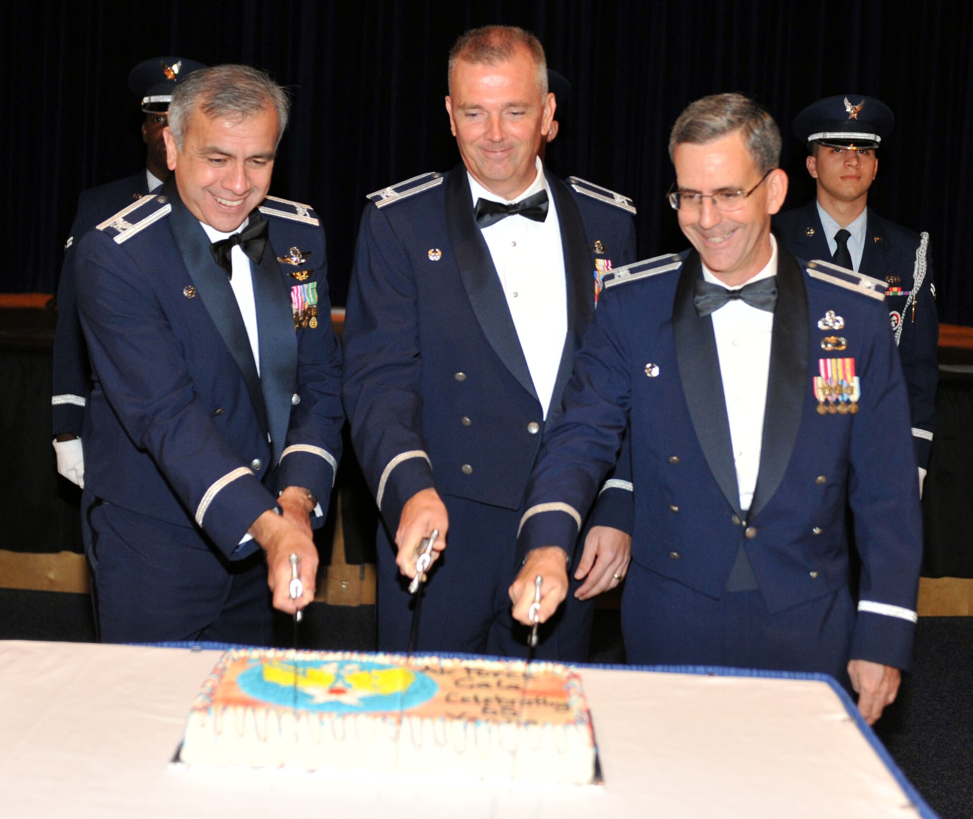 Col. John J. Hernandez, commander of the Kansas Air National Guard 184th Intelligence Wing, Col. Ricky N. Rupp, commander of the 22nd Air Refueling Wing, and Col. Donald C. Robison, deputy commander for maintenance for the Air Force Reserve 931st Air Refueling Group, cut into the Air Force birthday cake during the 65th Air Force Gala at McConnell Air Force Base, Kan., Sept. 14, 2012.  Approximately 400 Airmen attended the event to celebrate the heritage and history of the Air Force.  (U.S. Air Force photo by Airman 1st Class Maurice A. Hodges)