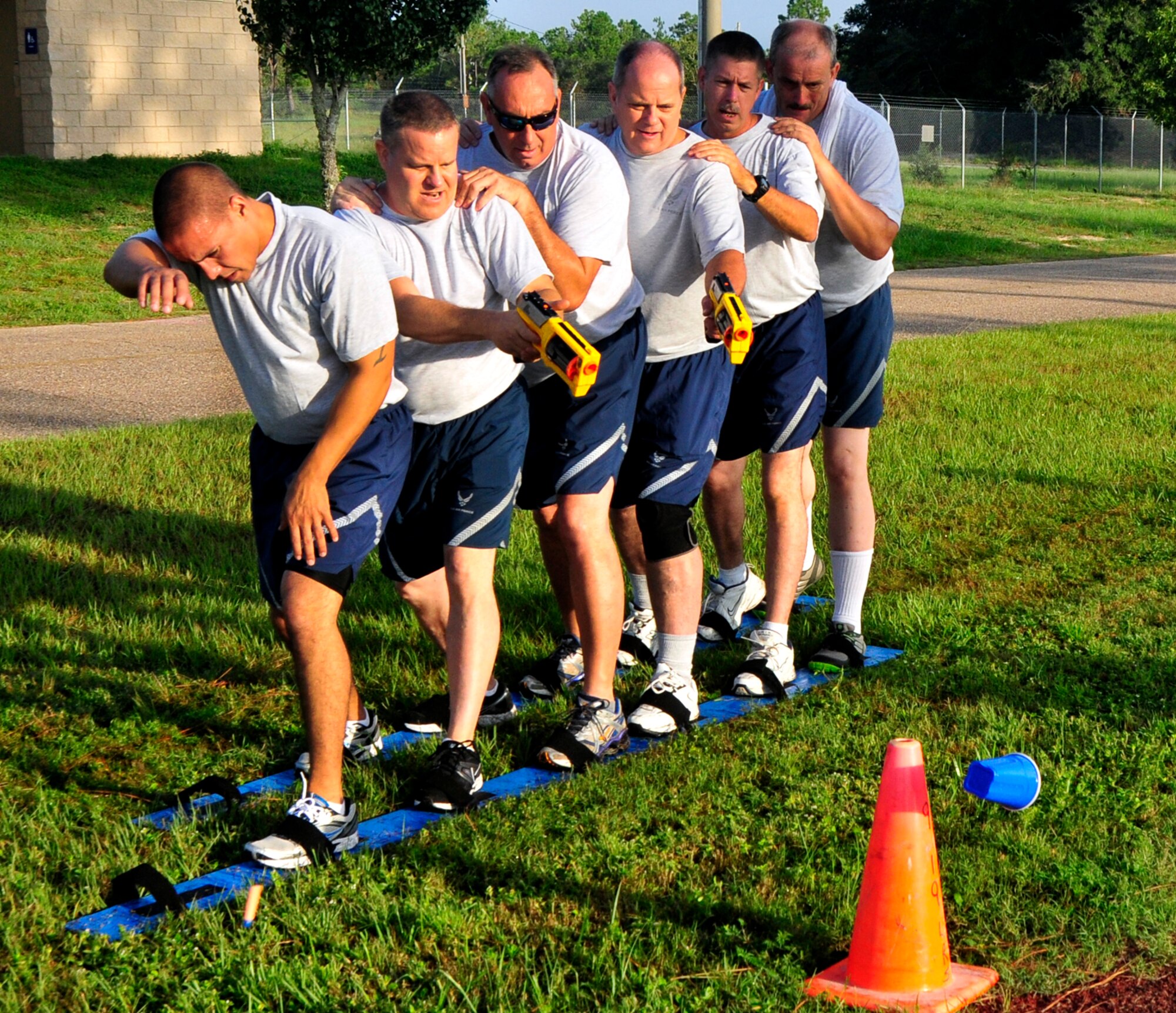 A team of six 919th Maintenance Group Airmen shoots at a target in the Combat Ski Shoot Challenge, part of the 919th MXG Olympics Sept 8, 2012 at Duke Field, Fla.  Members had to carefully maneuver on skis and hit targets using Nerf guns.  Points were awarded for the number of targets knocked down.  The event featured 12 different team events aimed at boosting unit morale and team building.  (U.S. Air Force photo/Tech. Sgt. Jasmin Taylor)