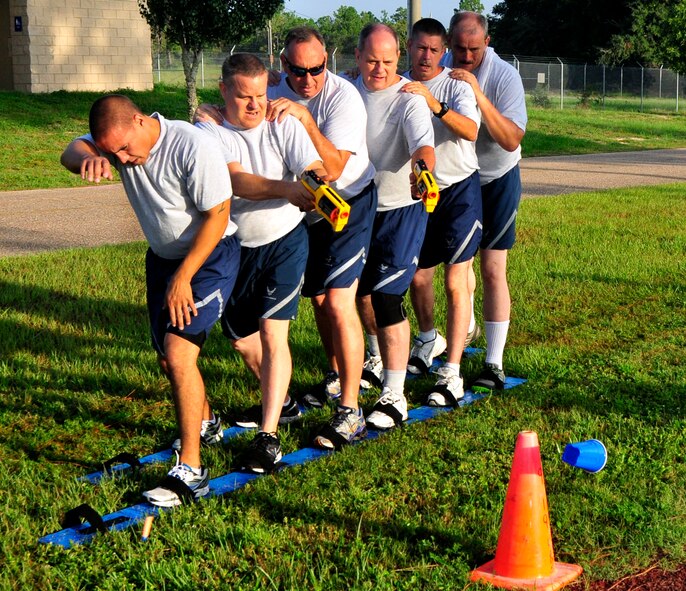 A team of six 919th Maintenance Group Airmen shoots at a target in the Combat Ski Shoot Challenge, part of the 919th MXG Olympics Sept 8, 2012 at Duke Field, Fla.  Members had to carefully maneuver on skis and hit targets using Nerf guns.  Points were awarded for the number of targets knocked down.  The event featured 12 different team events aimed at boosting unit morale and team building.  (U.S. Air Force photo/Tech. Sgt. Jasmin Taylor)