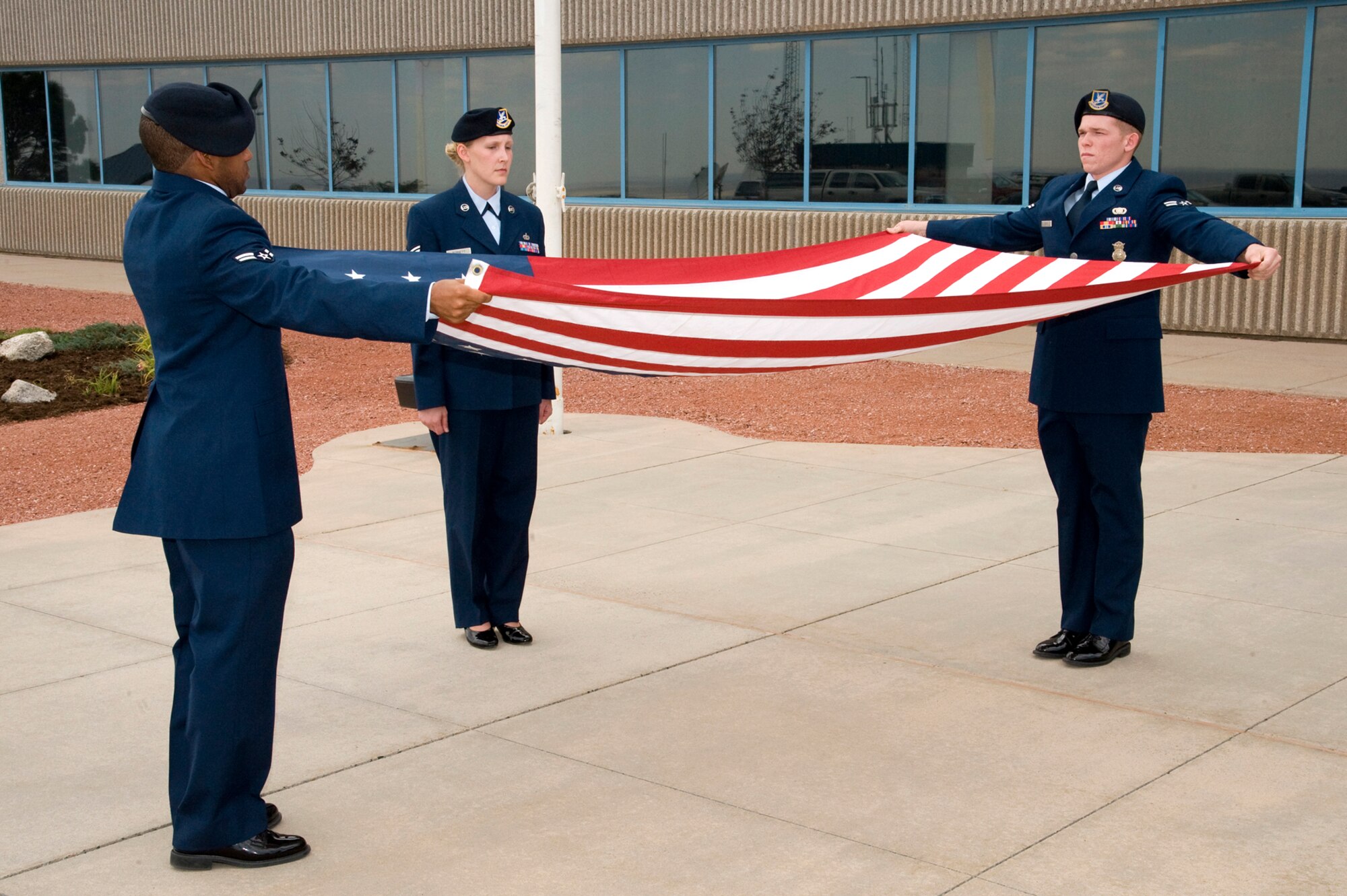 Members of the 721st Security Forces Squadron fold the flag during retreat at the Remembrance and Retreat ceremony Sept. 11, on Cheyenne Mountain Air Force Station. The ceremony commemorated the 11th anniversary of the 2001 terrorist attacks. (U.S. Air Force photo/Craig Denton)