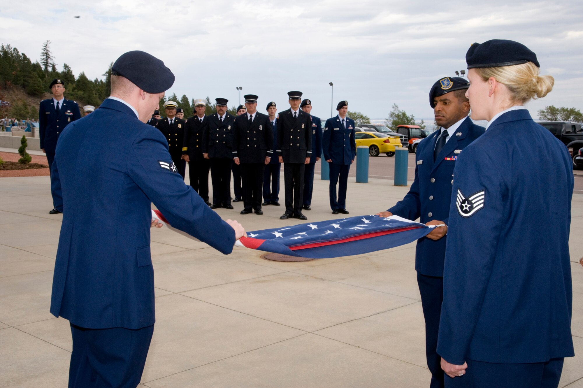 Members of the 721st Security Forces Squadron fold the flag during retreat at the Remembrance and Retreat ceremony Sept. 11, on Cheyenne Mountain Air Force Station. The ceremony commemorated the 11th anniversary of the 2001 terrorist attacks. (U.S. Air Force photo/Craig Denton)