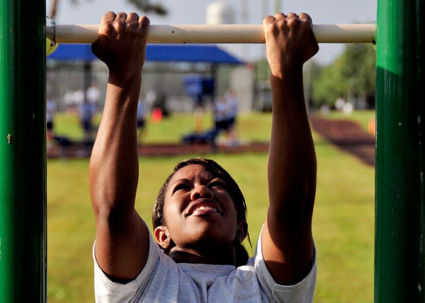 Senior Airman Cherrie James of the 919th Maintenance Squadron performs a pull-up during the 919th Maintenance Group Olympics Sept. 8, 2012 at Duke Field, Fla.  The event featured 12 different team events aimed at boosting unit morale and team building.  (U.S. Air Force photo/Tech. Sgt. Cheryl Foster)