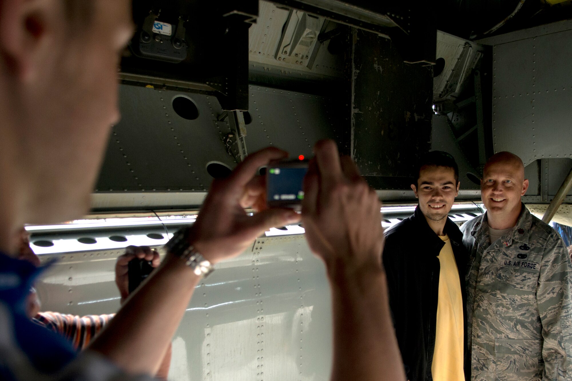 U.S. Air Force Maj. Karwin Weaver, 307th Aircraft Maintenance Squadron commander, poses for a photo with a spectator in the bomb bay of a 307th Bomb Wing B-52H Stratofortress during the Slovak International Air Fest, Sept. 1, 2012, Sliac, Slovakia. The event is the largest air show in Slovakia and an estimated 115,000 people attended the air fest. (U.S. Air Force photo by Master Sgt. Greg Steele/Released)