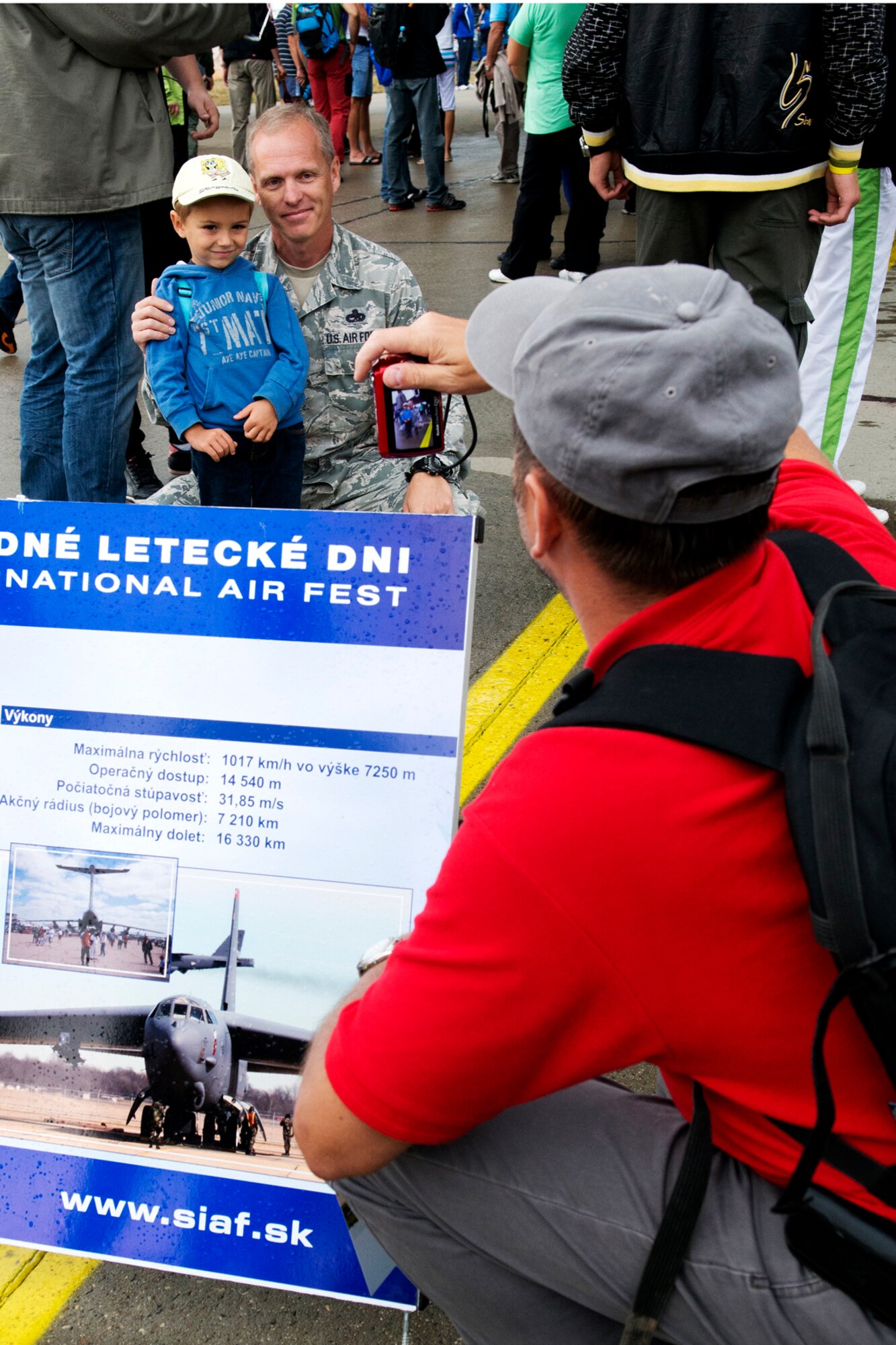 U.S. Air Force Master Sgt. Robbie Turcotte, 307th Aircraft Maintenance Squadron flight line expeditor, joins in for a photo during the Slovak International Air Fest 2012, Sept. 1, 2012, Sliac, Slovakia. An estimated 115,000 people attended the two-day air show, which featured displays and performances from aircraft across Europe and Asia. (U.S. Air Force photo by Master Sgt. Greg Steele/Released)