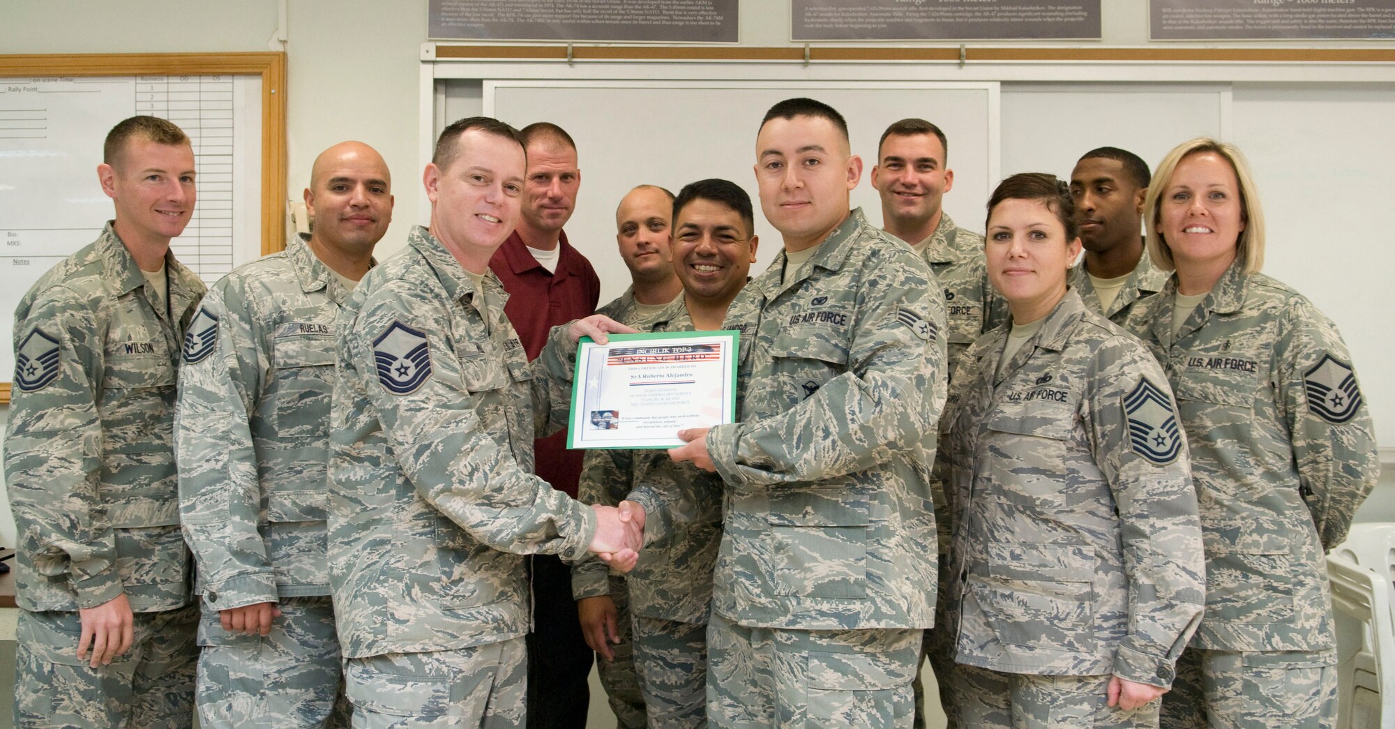 Senior Airman Roberto Alejandro, 39th Security Forces Squadron patrolman, receives the Unsung Hero Award from the Incirlik Top 3 organization Sept. 14, 2012, at Incirlik Air Base, Turkey. The Top 3 presents the Unsung Hero Award monthly to an Airman who demonstrates superior job performance and exceptional leadership. (U.S. Air Force photo by Senior Airman Marissa Tucker/Released)
