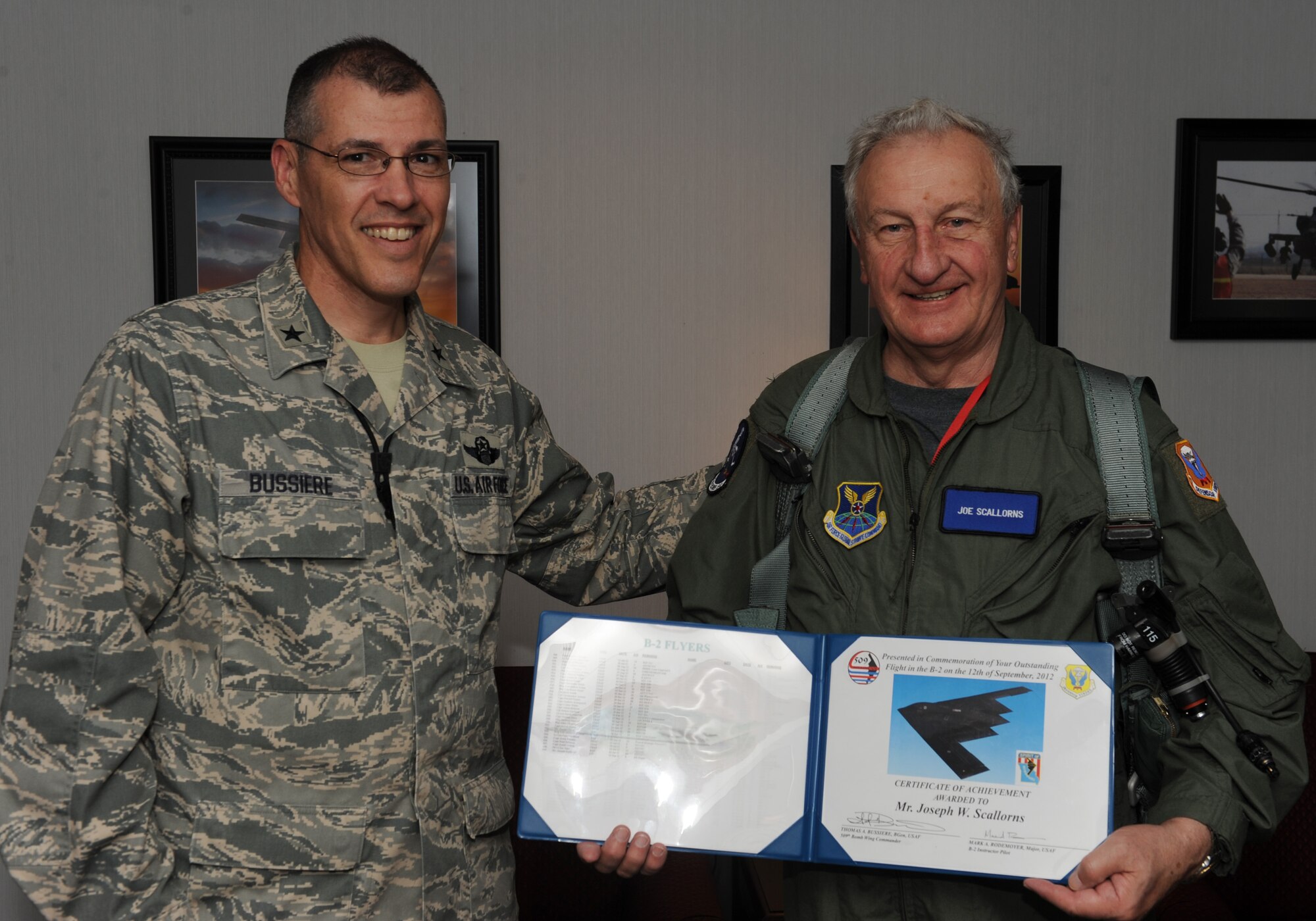 WHITEMAN AIR FORCE BASE, Mo. – Brig. Gen Thomas Bussiere, 509th Bomb Wing commander, presents Joe Scallorns, a board member of Whiteman Air Force Base's Community Council, with a certificate after his B-2 incentive flight Sept. 12. (U.S. Air Force photo/Airman 1st Class Bryan Crane) (Released)
