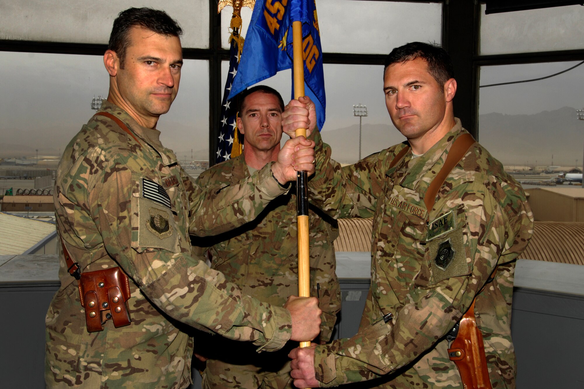 Brig. Gen. Joseph Guastella, 455th Air Expeditionary Wing commander, presents the 455th Expeditionary Operations Group guidon to Col. Michael Millen as Millen assumes command of the group at Bagram Airfield, Afghanistan, Sept. 17, 2012. Millen has extensive experience flying both the A-10 and OA-10 Thunderbolt II airframes. (U.S. Air Force photo/SSgt Jeff Nevison)