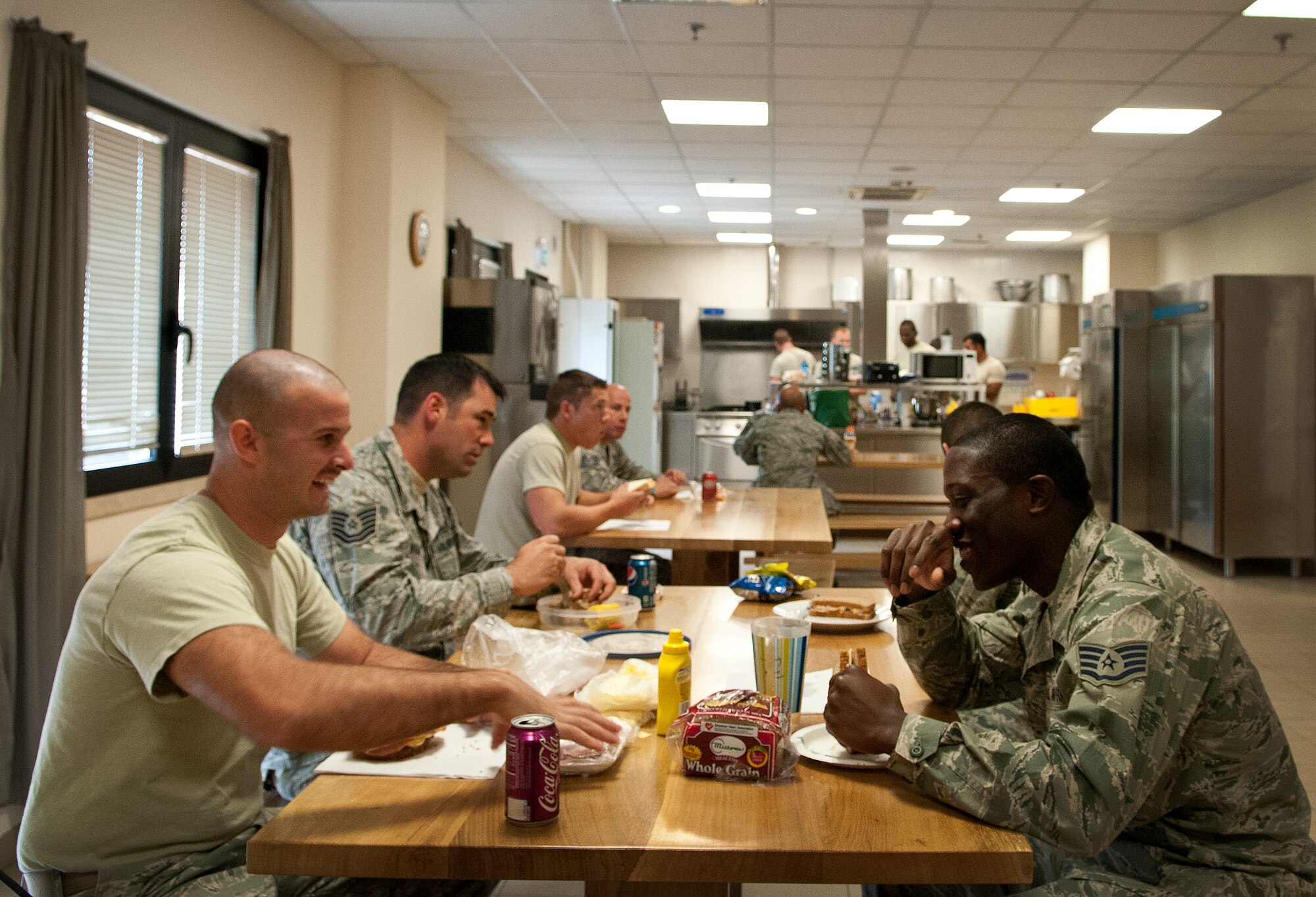 Firefighters from the 31st Civil Engineer Squadron eat lunch in the Area F fire station Sept. 13 at Aviano Air Base, Italy. During their 24-hour shifts, Aviano firefighters must work out, eat and sleep in the firehouse. (U.S. Air Force photo by Senior Airman Katherine Tereyama)
