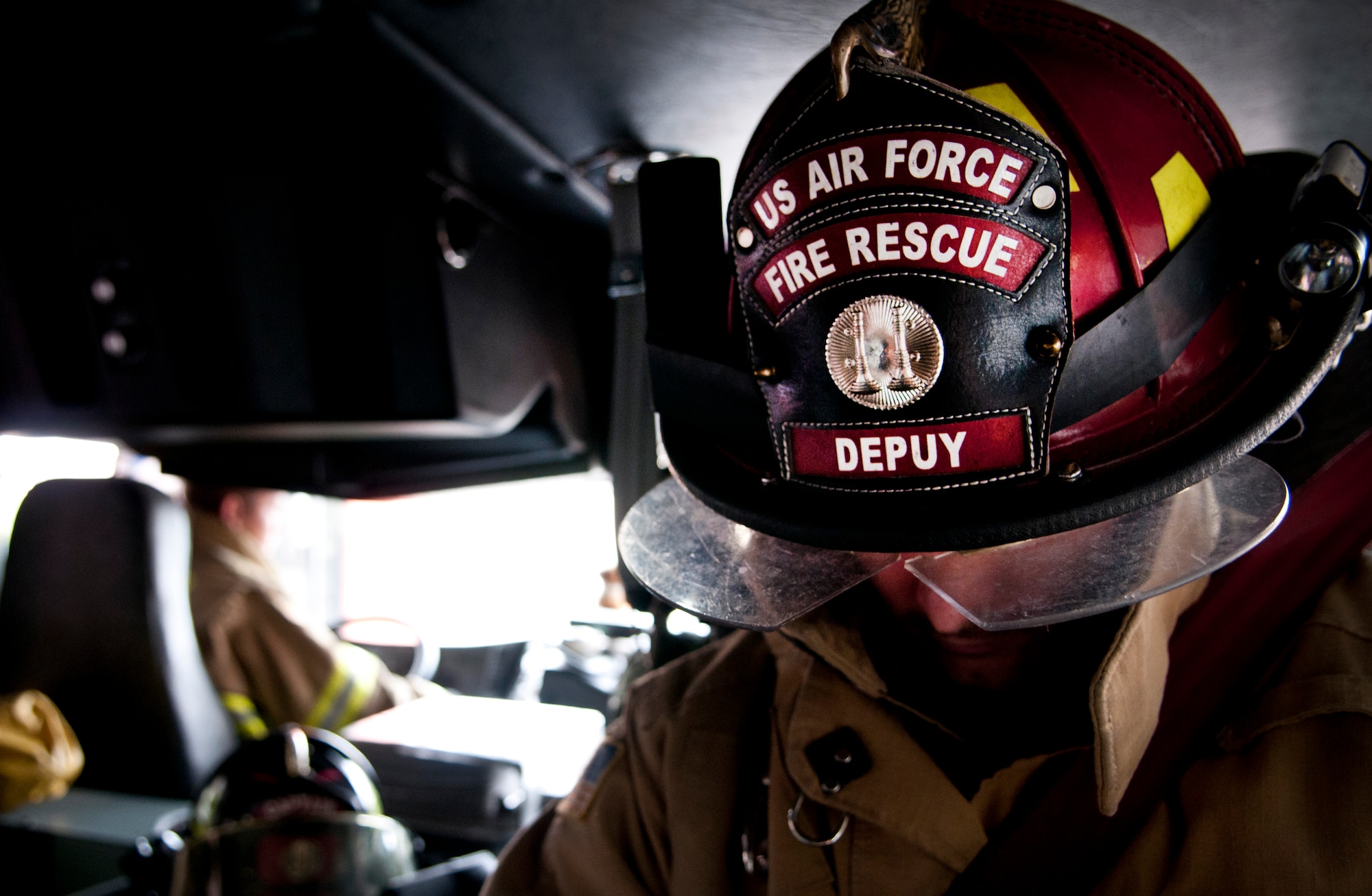 Tech. Sgt. Christopher Depuy, 31st Civil Engineer Squadron firefighter, sits in a fire truck on the way to a simulated fire during a training exercise Sept. 13 at Aviano Air Base, Italy. Firefighters train daily, honing their skills in fire protection, automobile extrications, confined space rescue, aircraft rescue and more. (U.S. Air Force photo by Senior Katherine Tereyama)