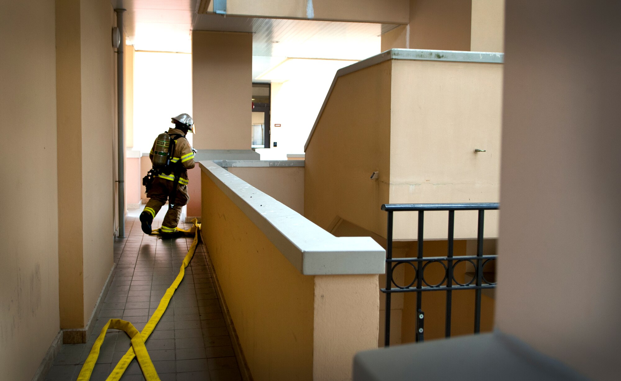 Staff Sgt. Daniel Nembhard, 31st Civil Engineer Squadron firefighter, runs to put out a simulated fire in a base dormitory during a training exercise Sept. 13 at Aviano Air Base, Italy. Aviano firefighters are responsible for providing fire protection to all base facilities. (U.S. Air Force photo by Senior Airman Katherine Tereyama)