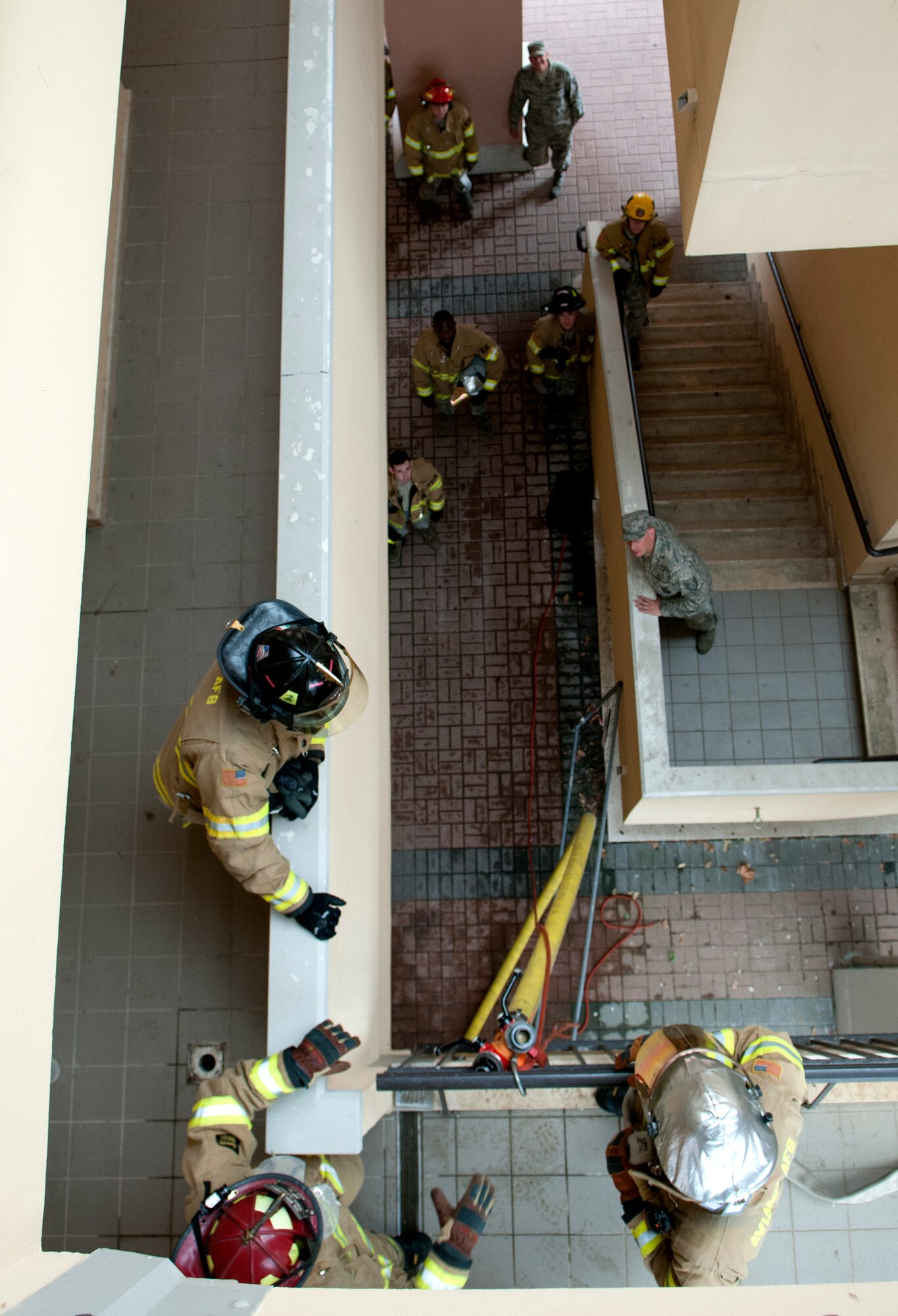Firefighters from the 31st Civil Engineer Squadron discuss the best way to hook up a fire hose during a training exercise Sept. 13 at Aviano Air Base, Italy. During training, Aviano firefighters execute a rescue mission as if it is real world, and then talk about ways to improve their plan of action. (U.S. Air Force photo by Senior Airman Katherine Tereyama)