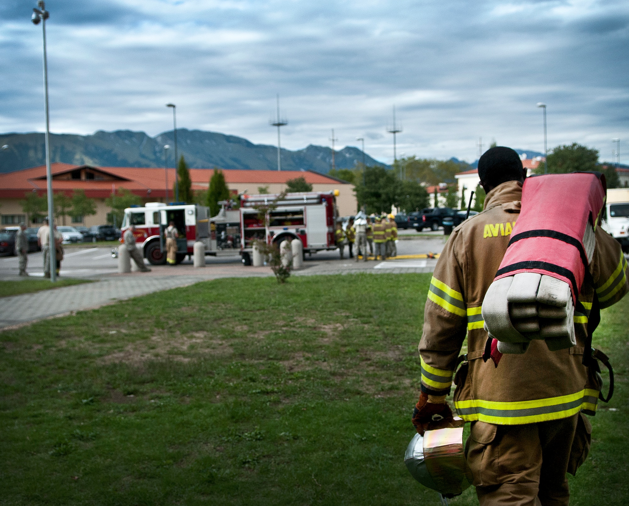 Staff Sgt. Daniel Nembhard, 31st Civil Engineer Squadron firefighter, carries a fire hose after completing a training exercise Sept. 13 at Aviano Air Base, Italy. Aviano firefighters train daily, simulating fire emergencies, aircraft accidents and other possible contingencies in preparation for real world incidents. (U.S. Air Force photo by Senior Airman Katherine Tereyama)