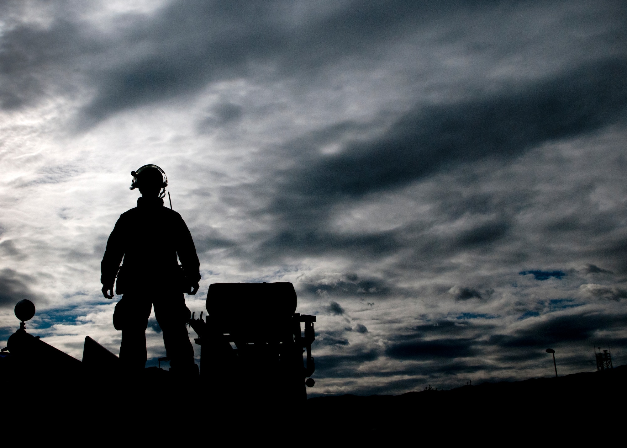 Staff Sgt. Daniel Nembhard, 31st Civil Engineer Squadron firefighter, stands on top of a fire truck before reeling in a hose Sept. 13 during a training exercise at Aviano Air Base, Italy. The firefighters used the training exercise to determine entry and exit points in case of a fire in base dormitory buildings. (U.S. Air Force photo by Senior Airman Katherine Tereyama)